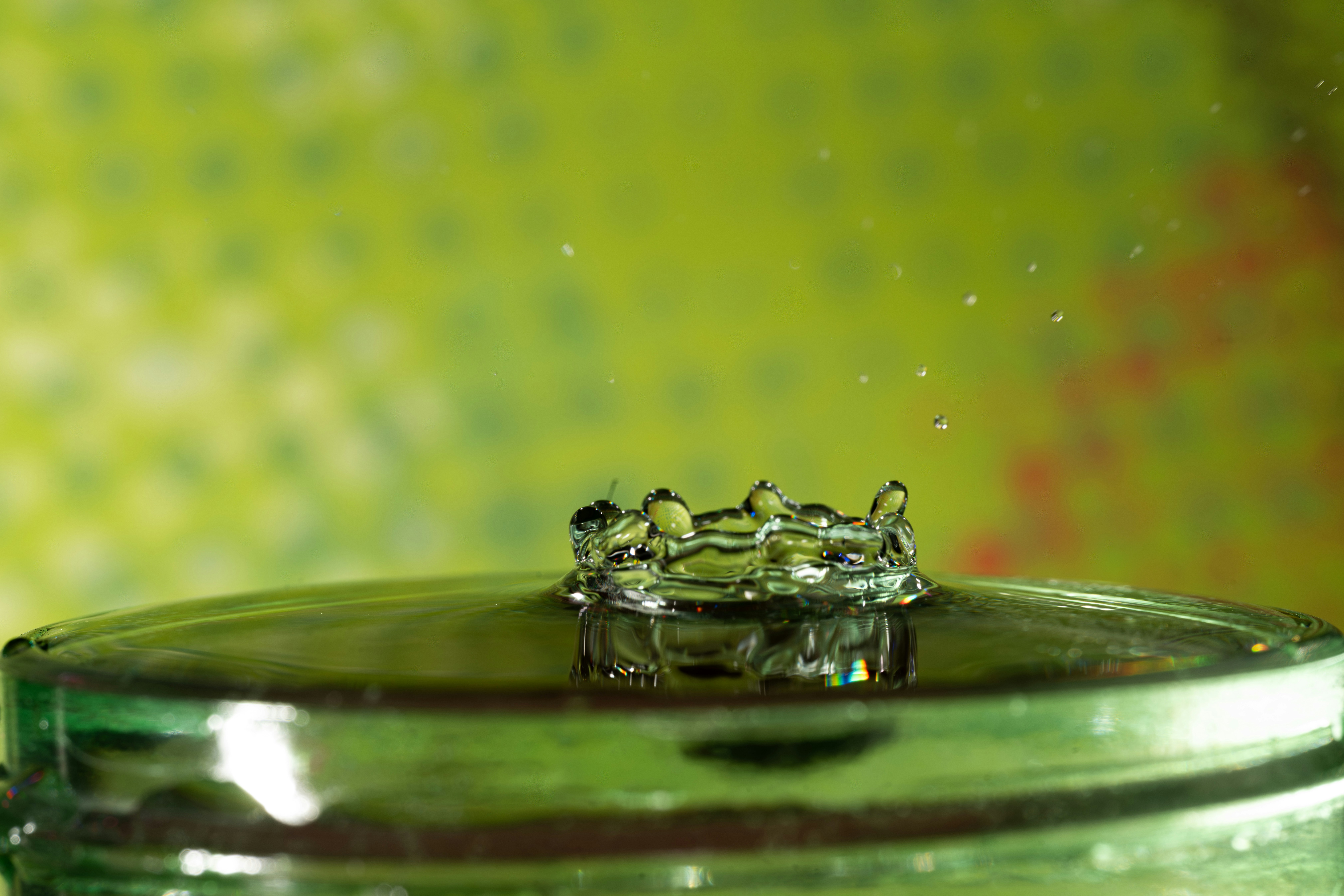 Water droplet crown forming on a surface.