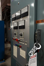 Industrial control panel with gauges and switches.