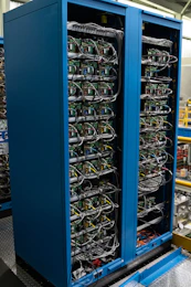 Two blue cabinets filled with complex electronic components.
