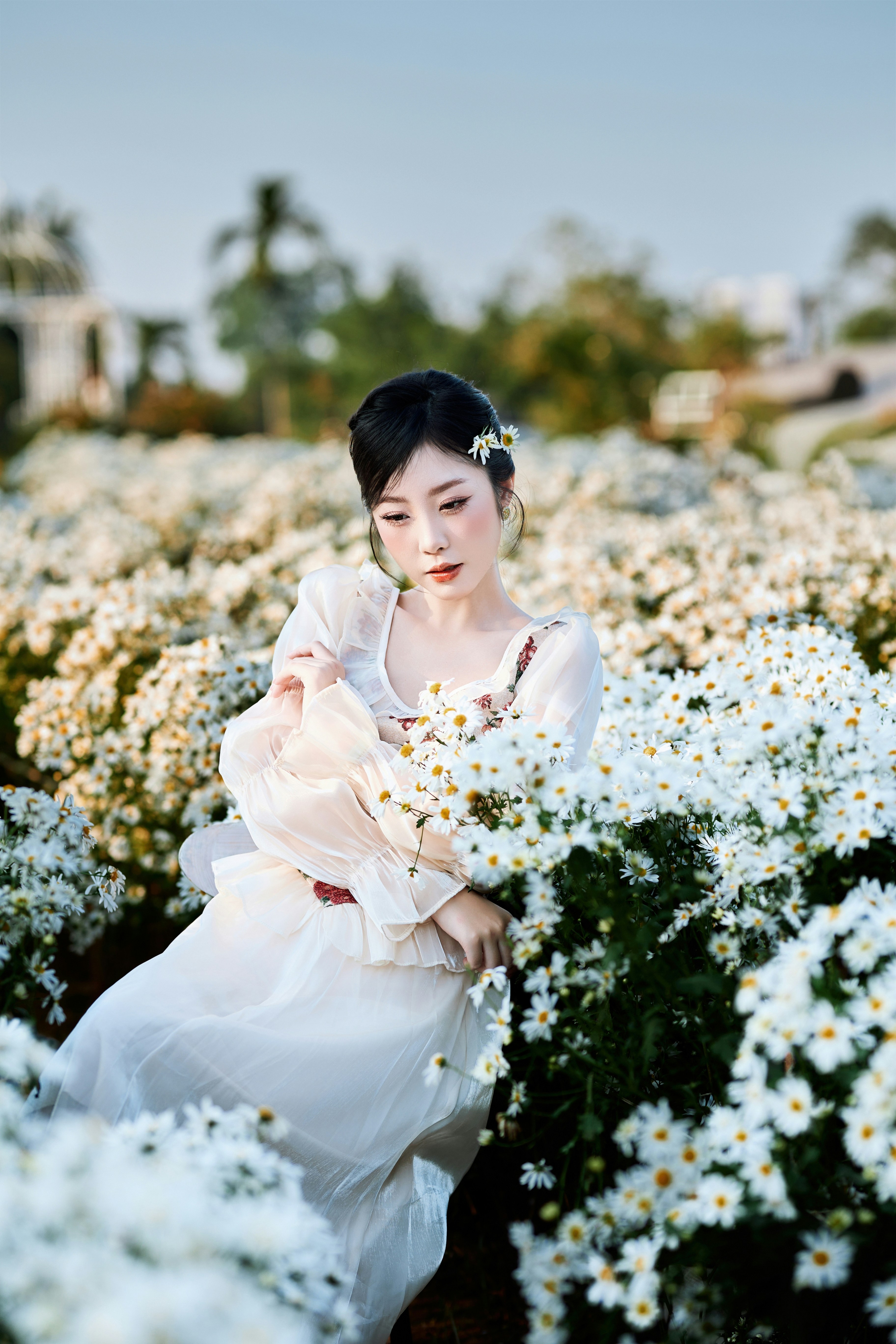 Woman in traditional dress amidst white flowers