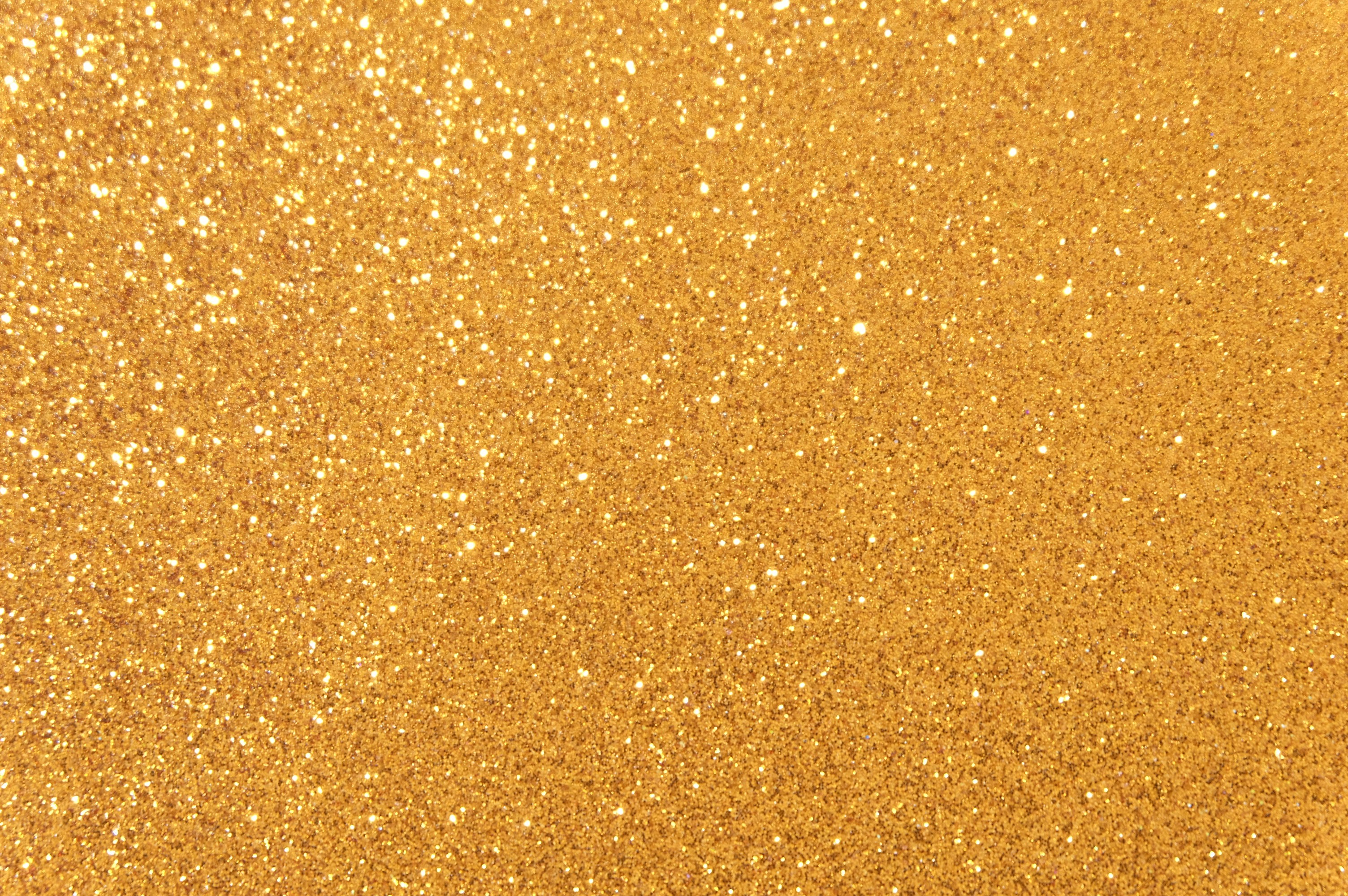 Eine Nahaufnahme eines glitzernden goldenen Hintergrunds