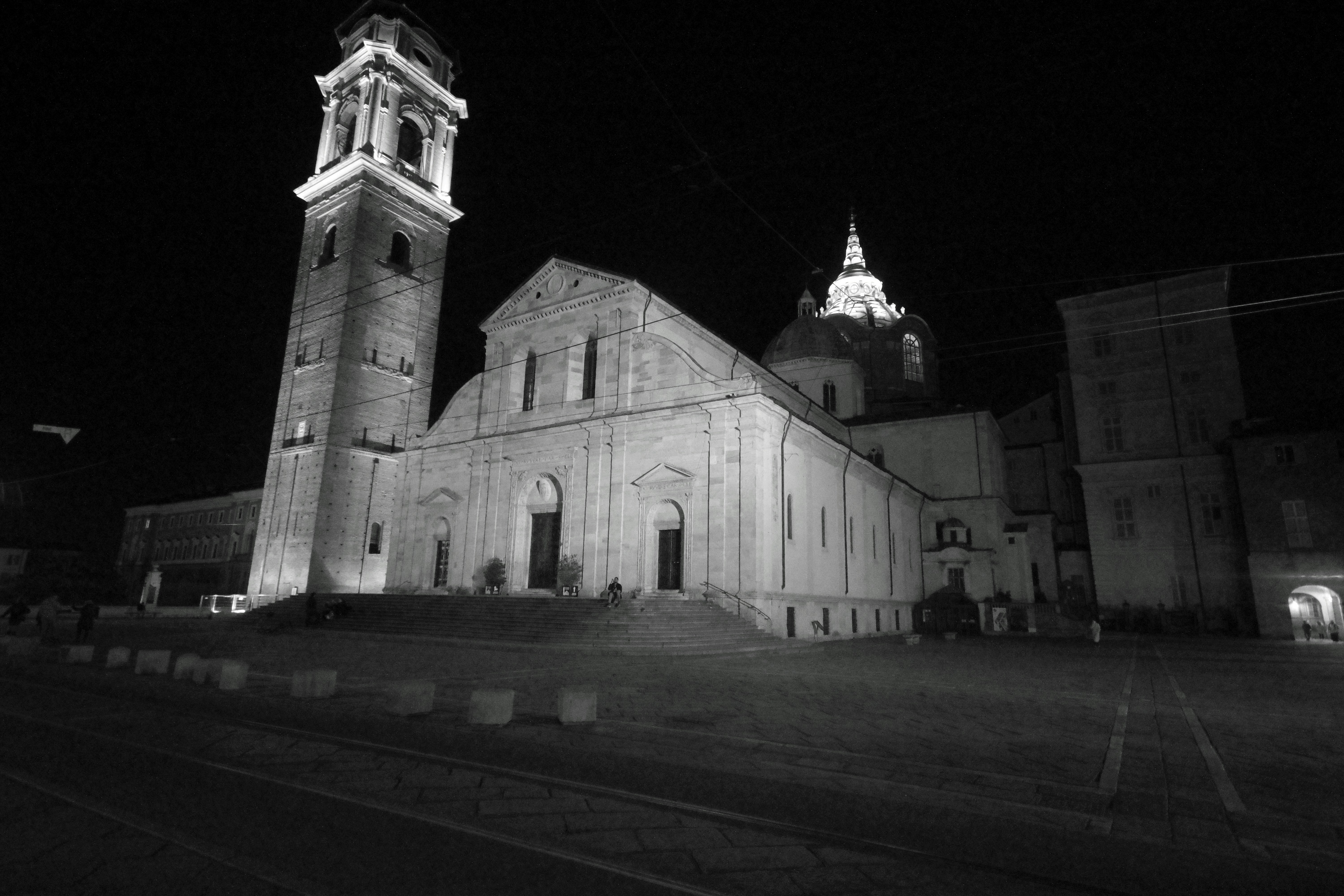 A large church illuminated at night with a bell tower.