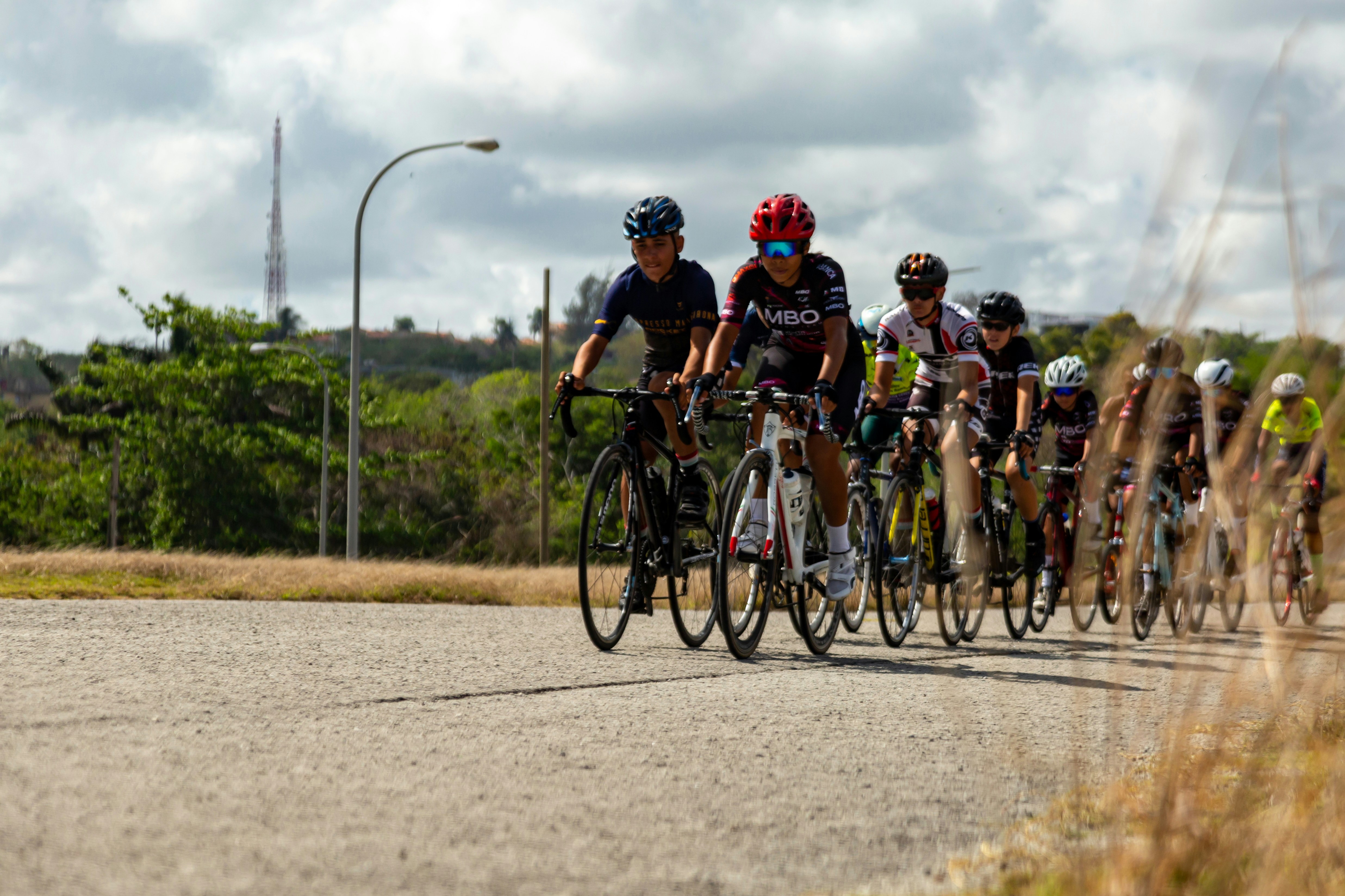 Group of cyclists racing on a paved road.