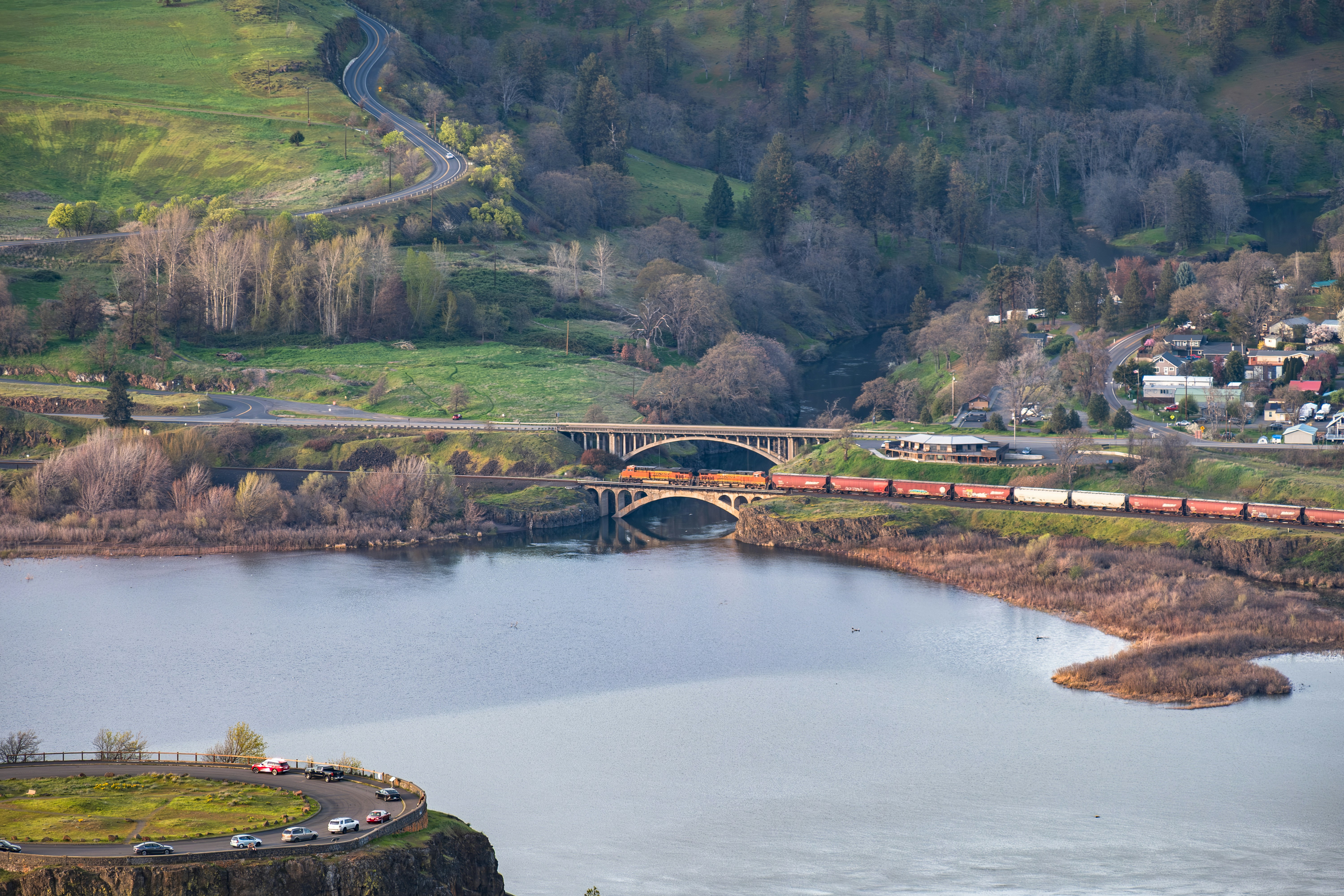 A train crosses a bridge over a river.