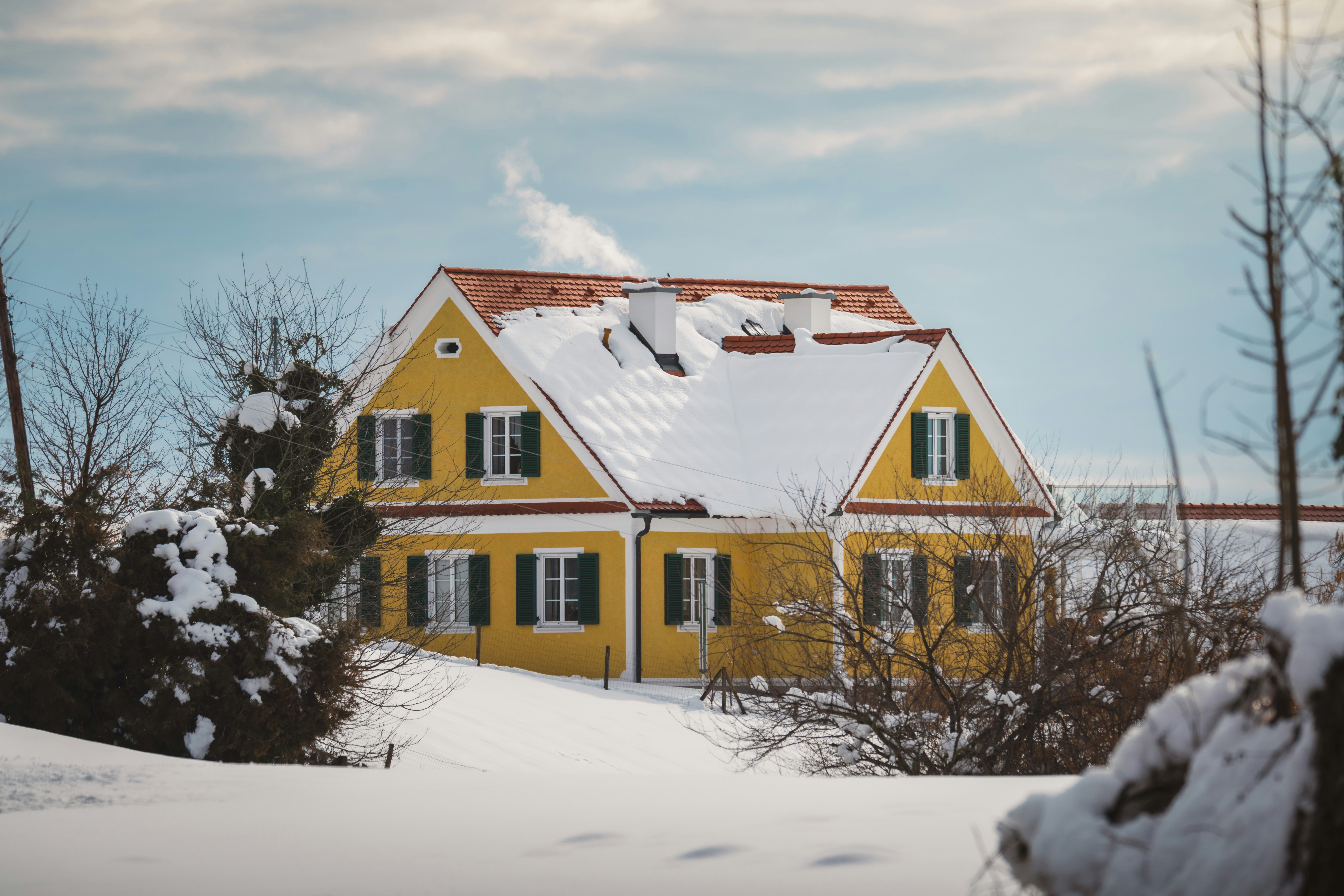 homeowner checking thermostat in cold house during winter - emergency hvac tips for homeowners