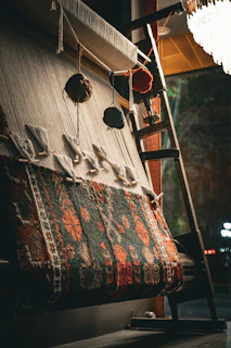 A partially woven rug on a loom