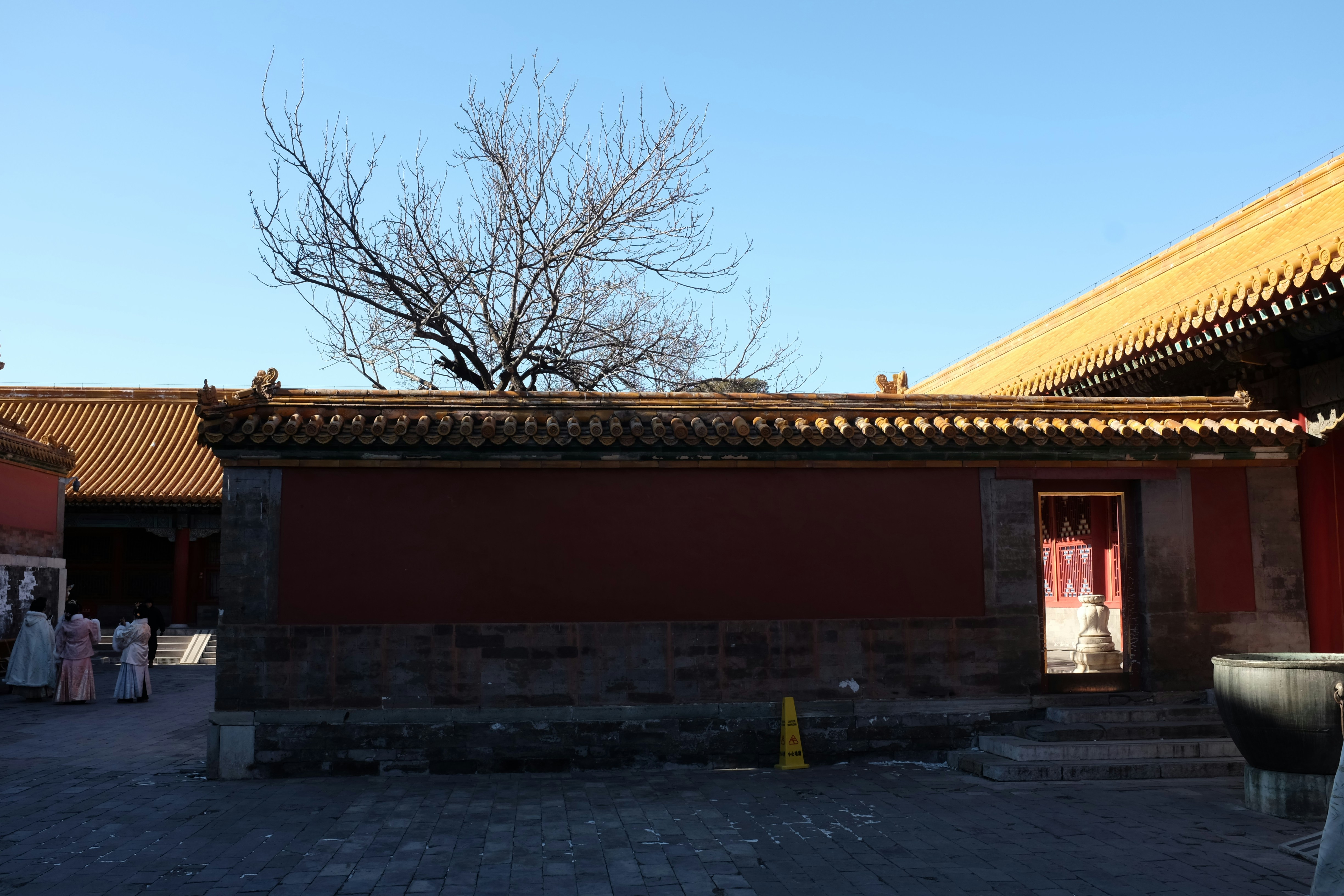 Traditional chinese architecture with red walls and yellow roofs.