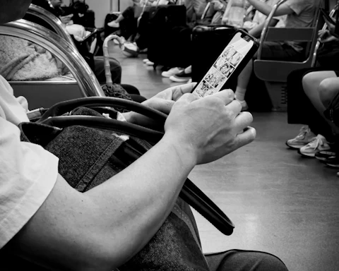 Someone scrolling on their phone on a train