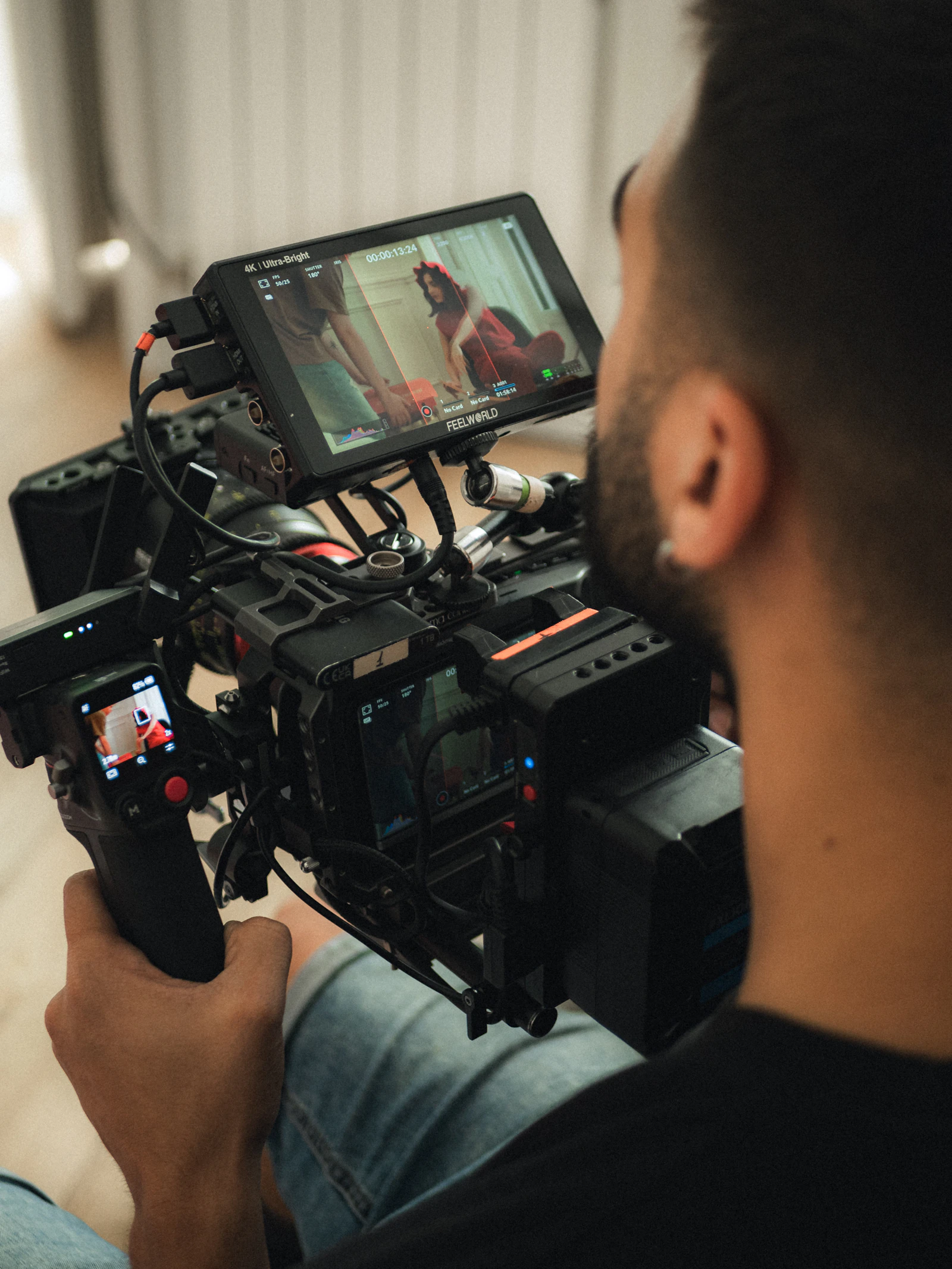 Filmmaker monitoring a scene through a professional camera rig