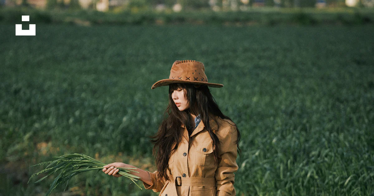Woman in hat and boots standing in a muddy field. photo – Free ...