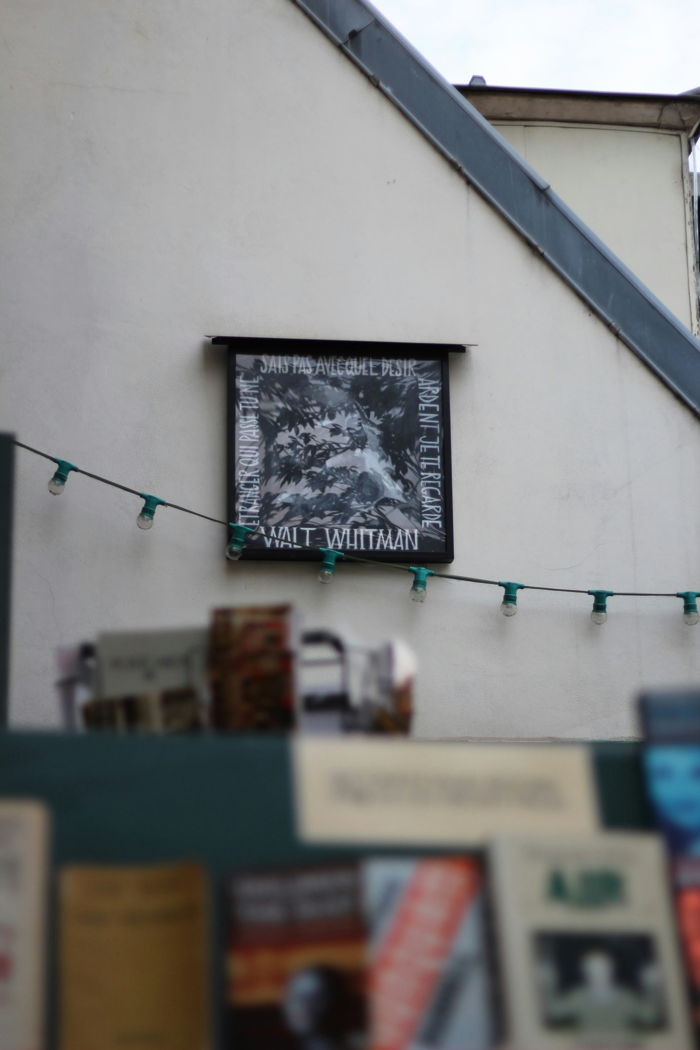Black and white poster of walt whitman on building