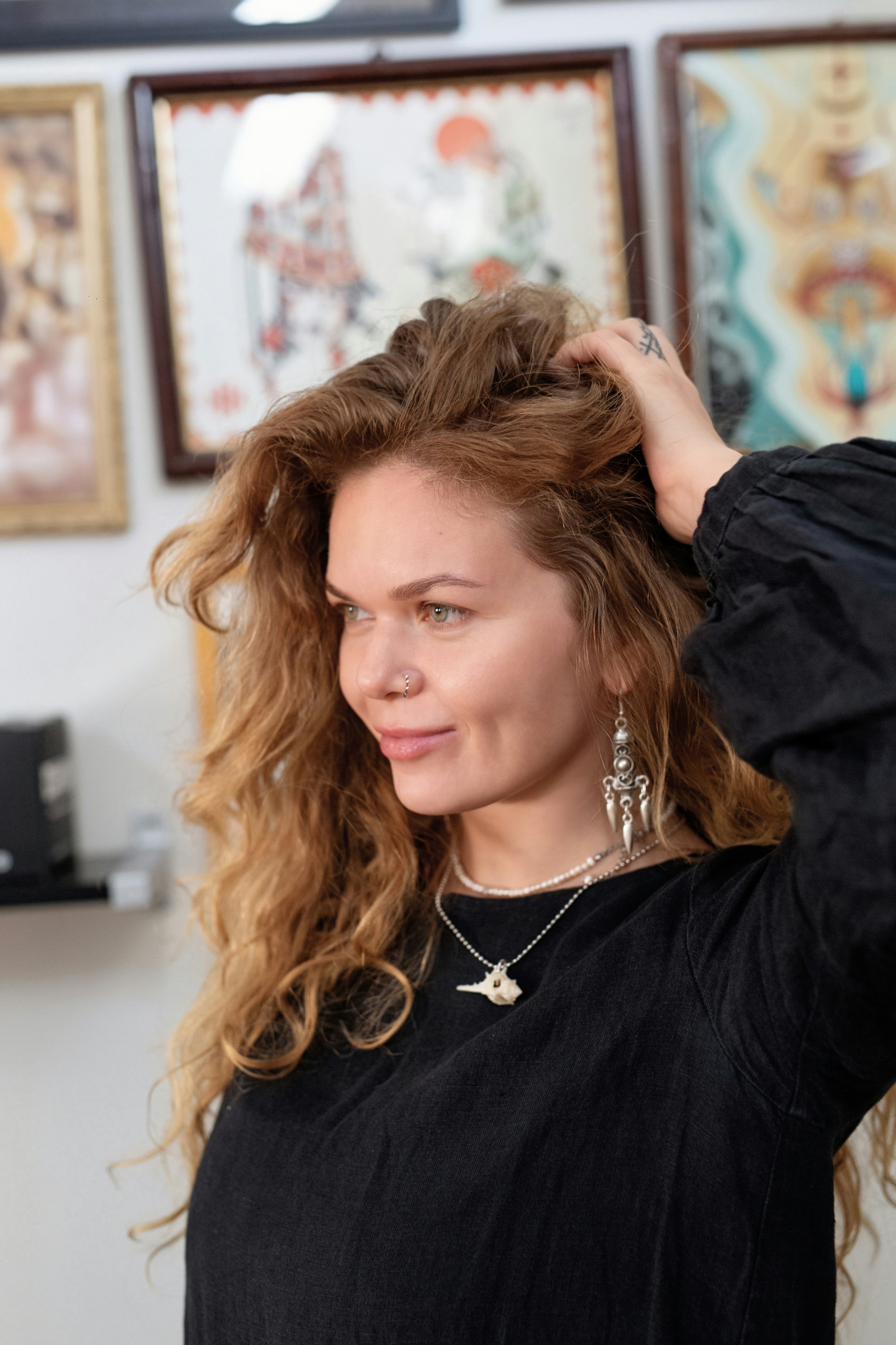 Woman with curly red hair and distinctive earrings