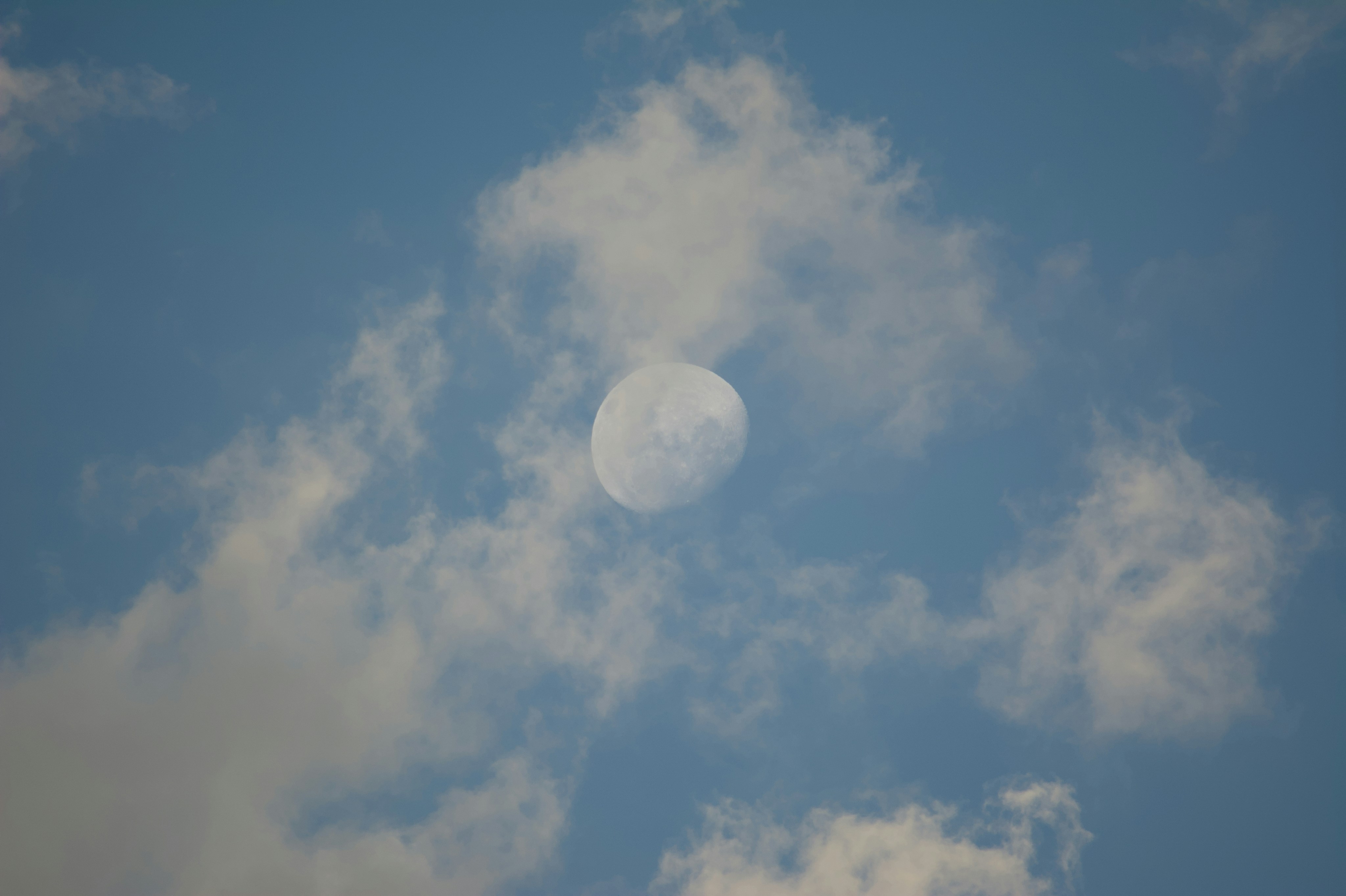 The moon is visible in the daytime sky.
