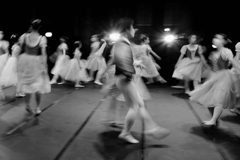 Before: motion-blurred group of young dancers moving through rehearsal