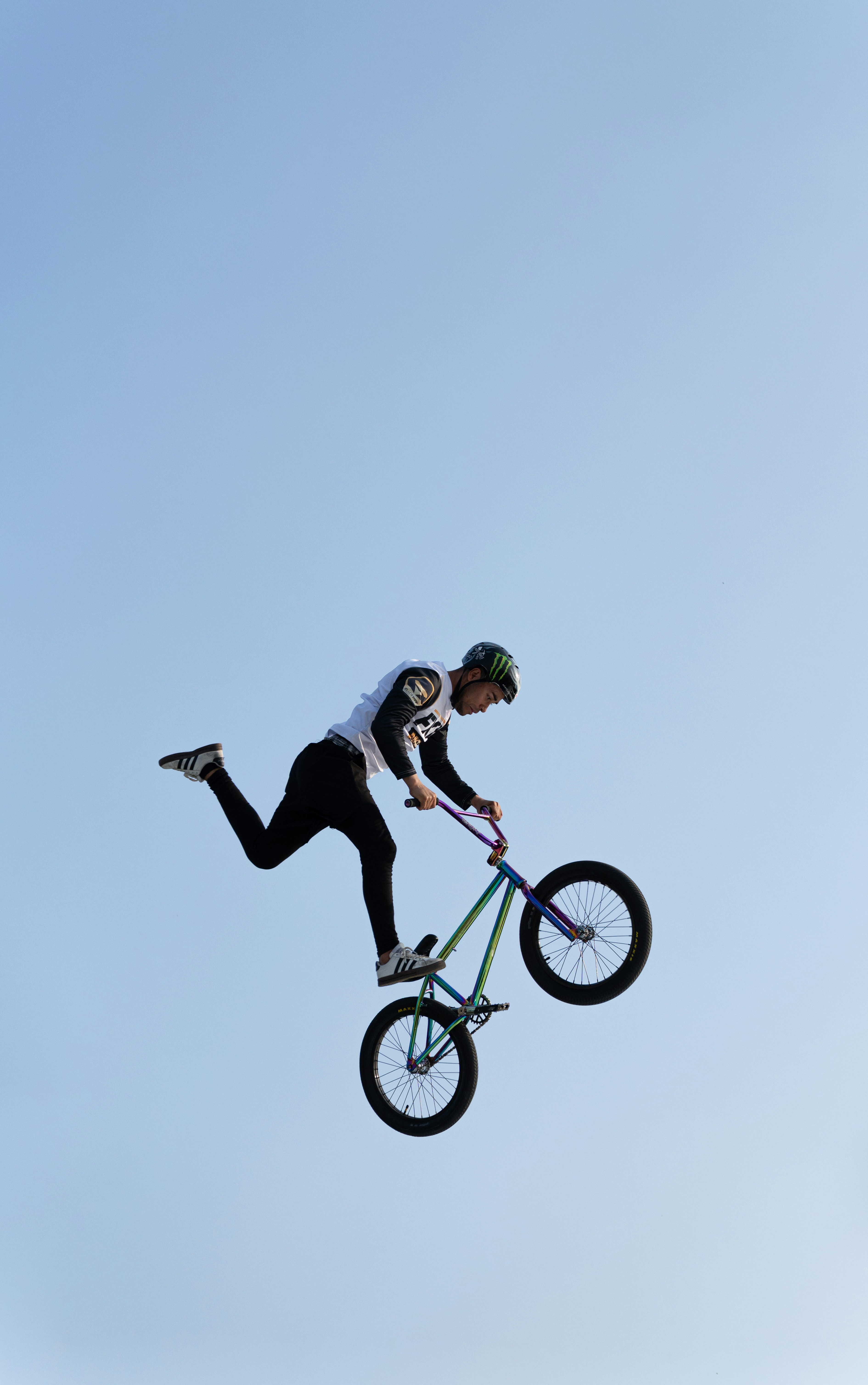 Bmx rider performing a trick against a clear sky