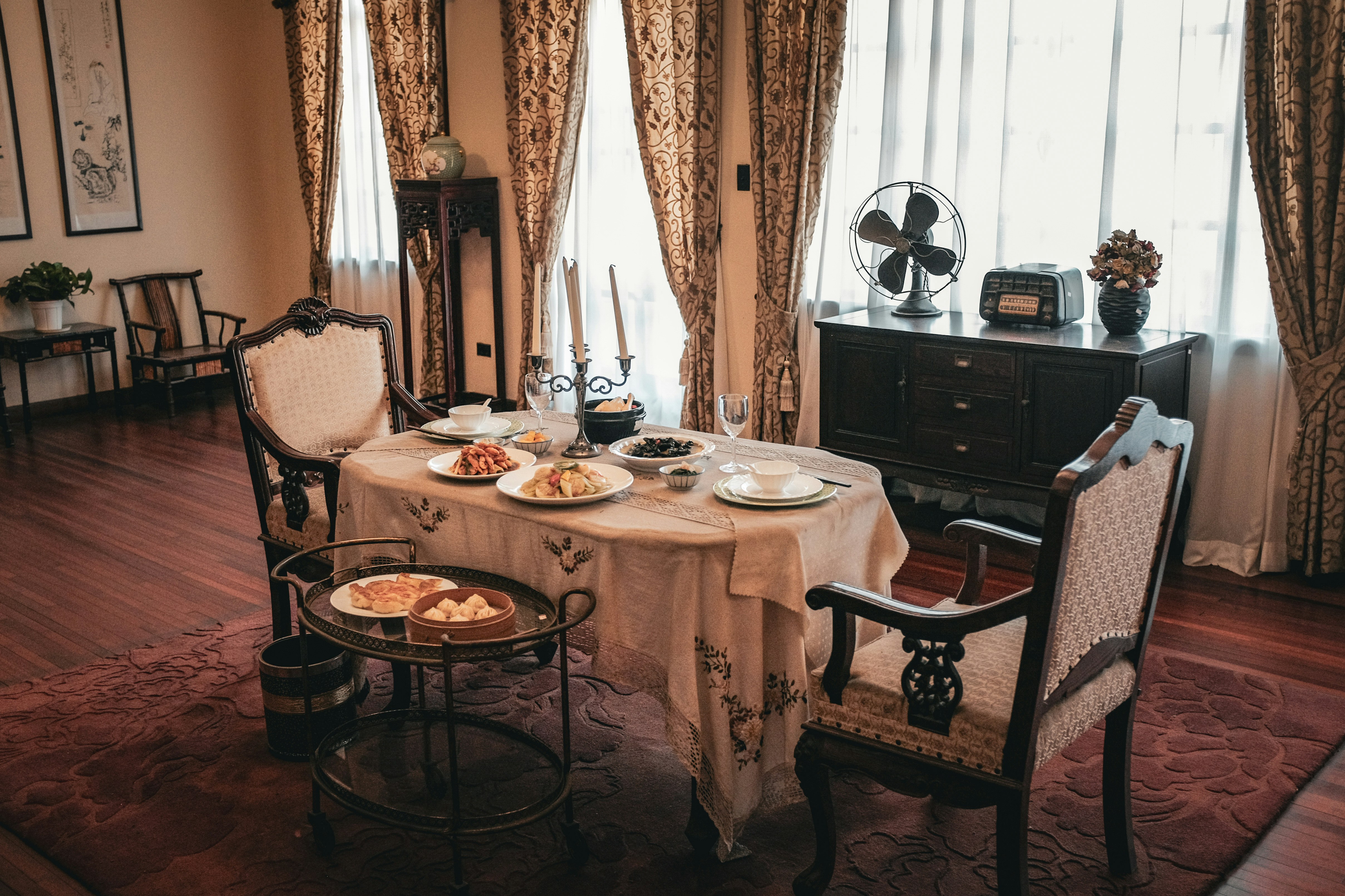 A dining table set with food in a vintage room.