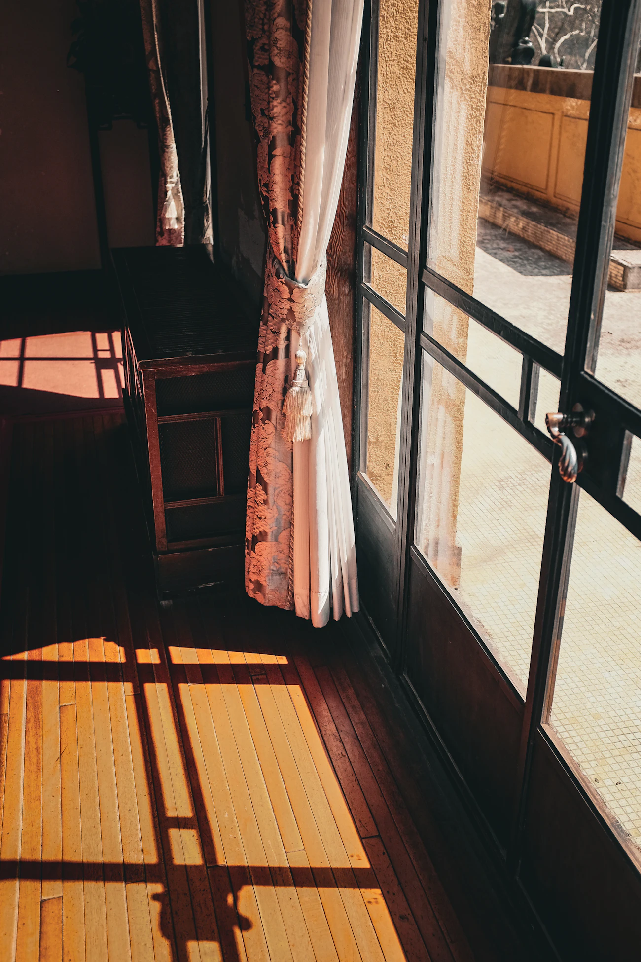Late-afternoon light coming through a window onto a wooden floor, no people. Stock image, placeholder.
