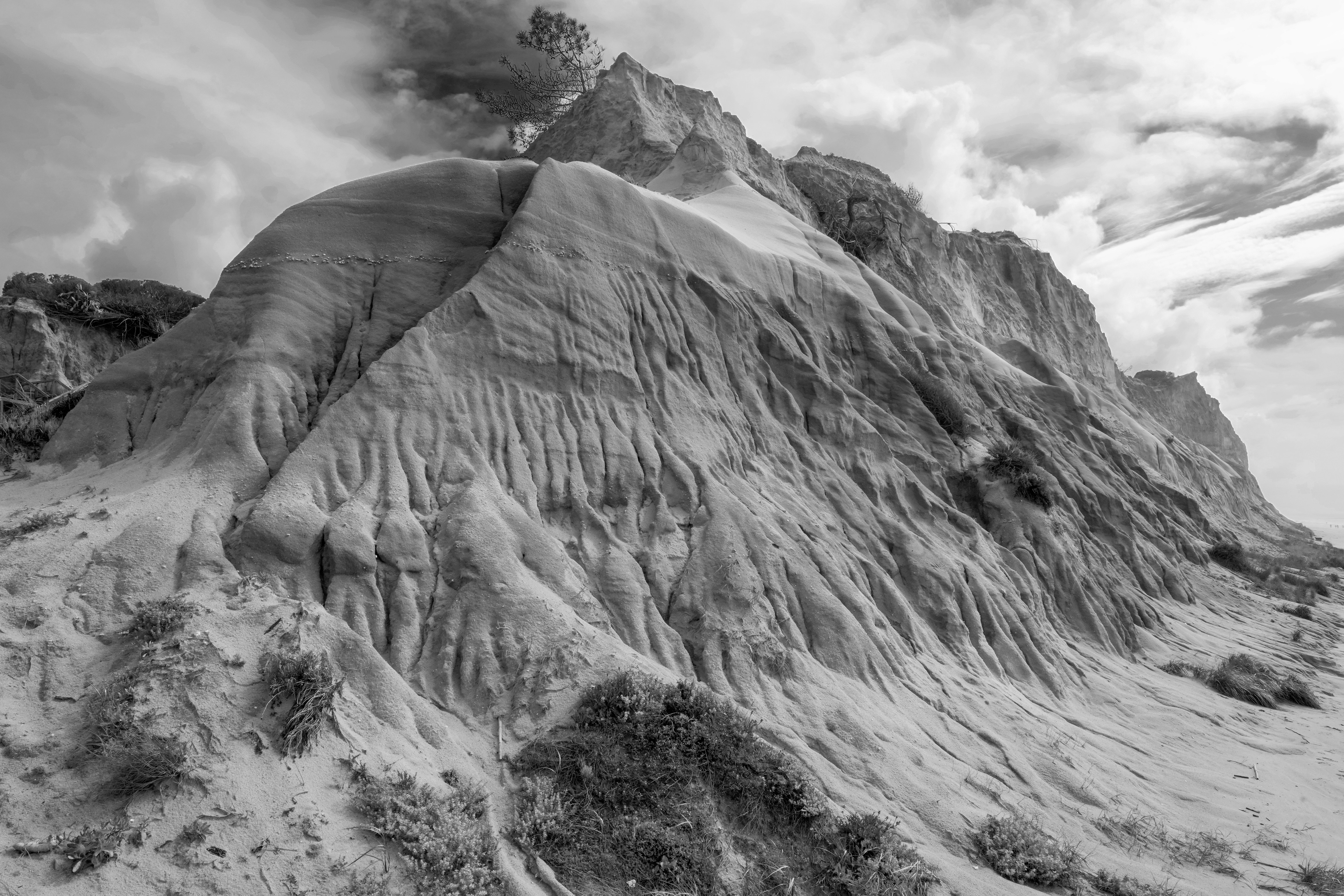 Dramatic mountain landscape with textured slopes under a cloudy sky