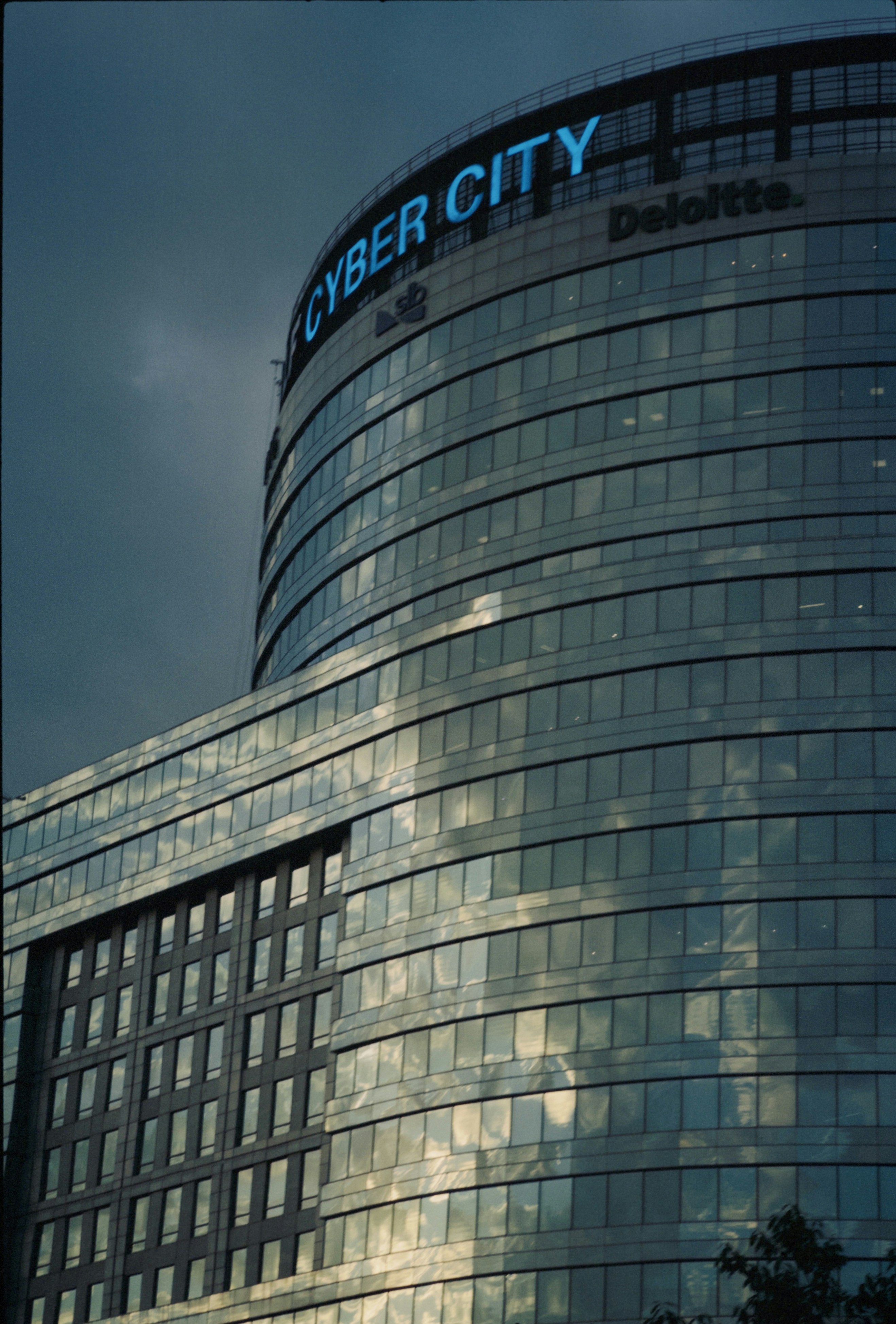 Modern glass building with "cyber city" sign