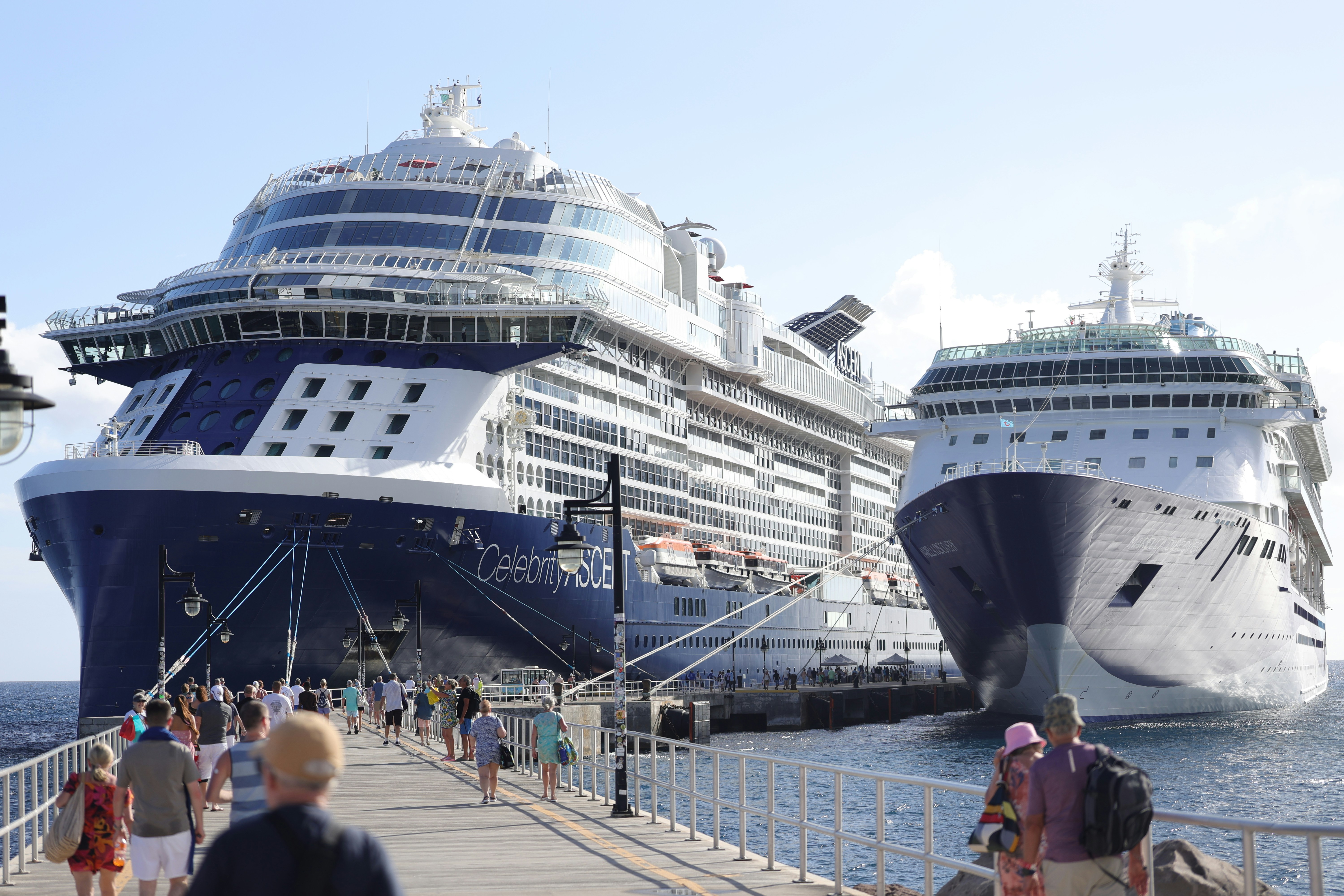 Little and large passenger cruise ships docked to let the passengers off to look around,