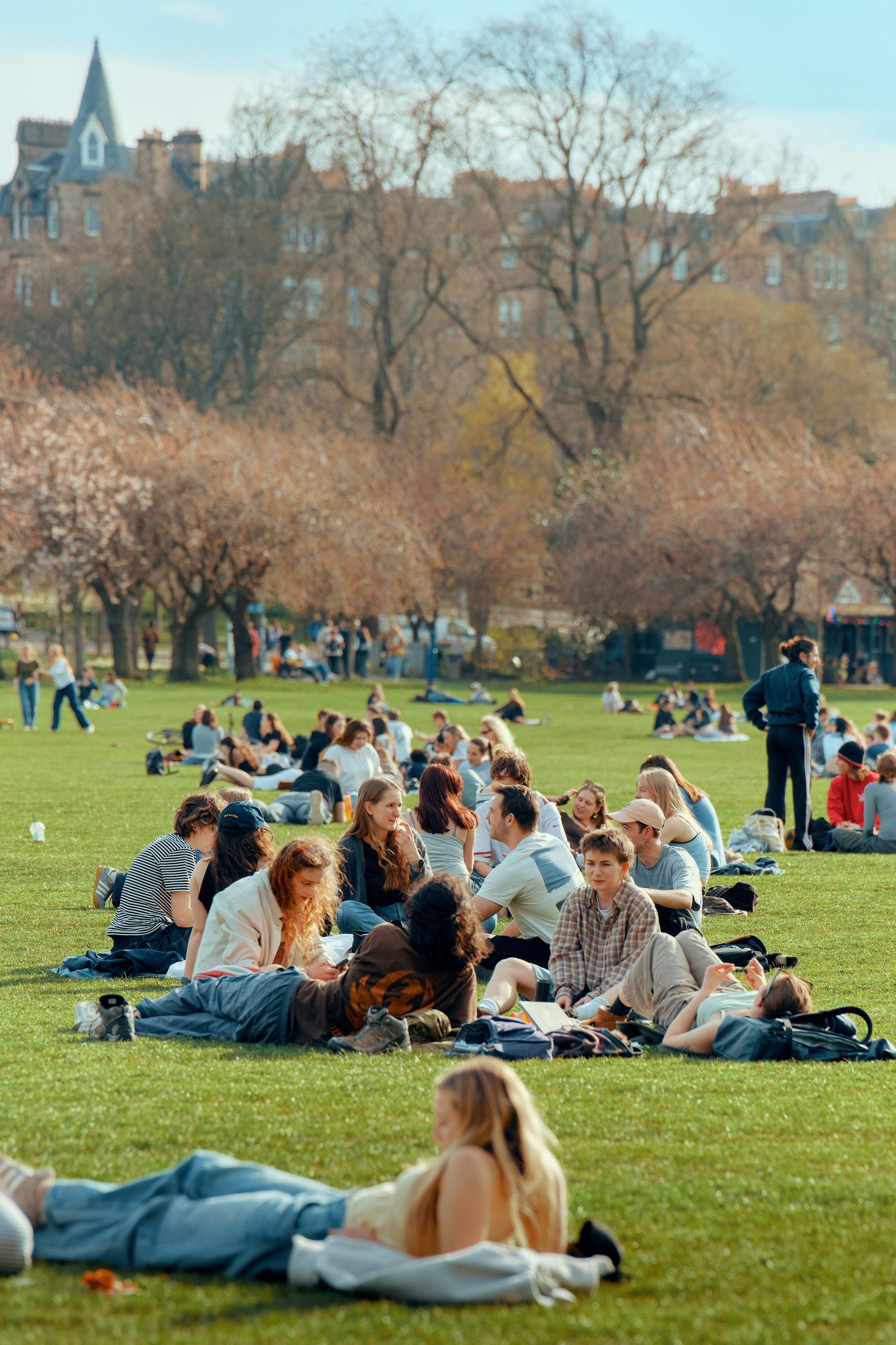 People relaxing on a sunny day in a park.