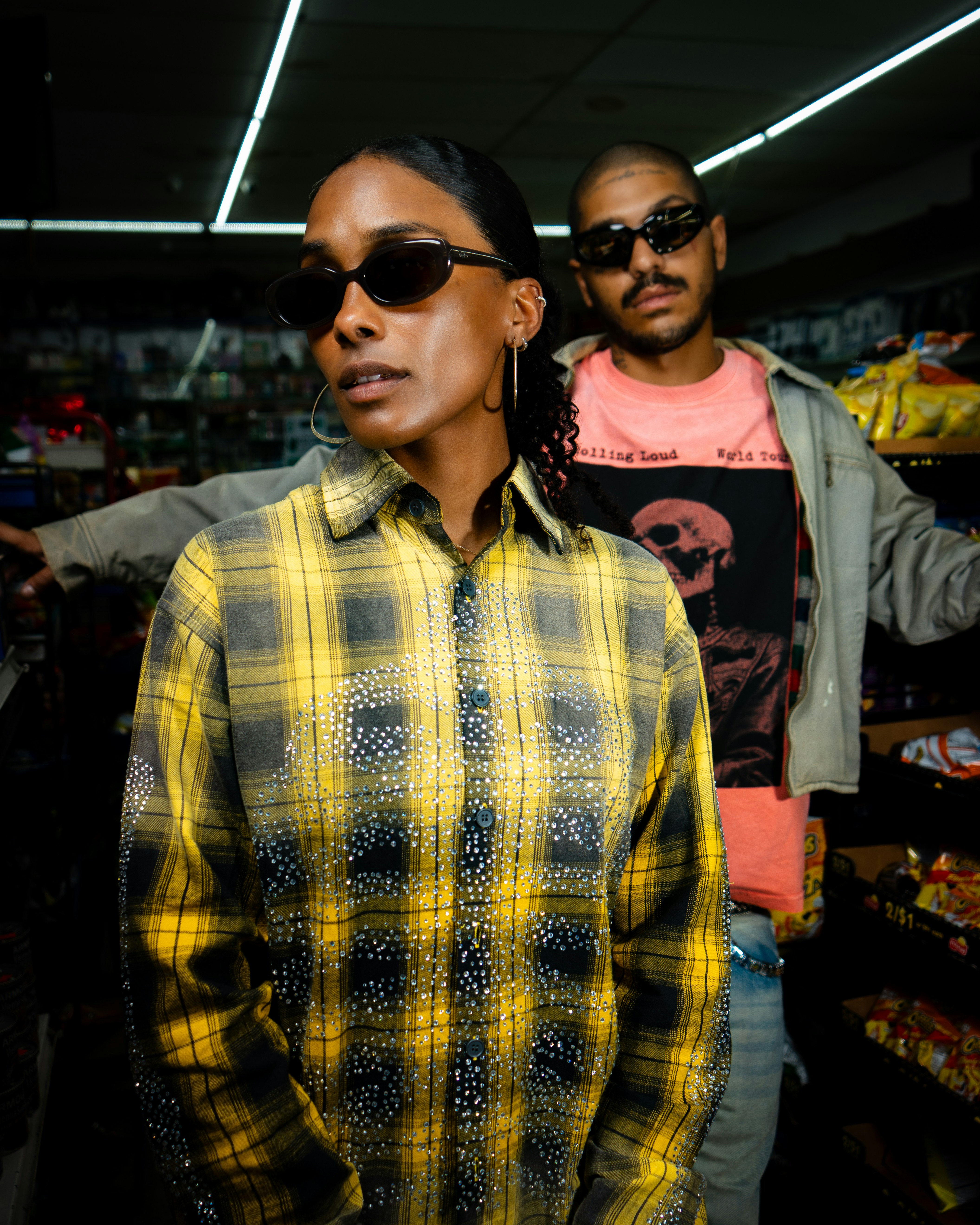 Duas pessoas usando óculos escuros em uma loja de conveniência.