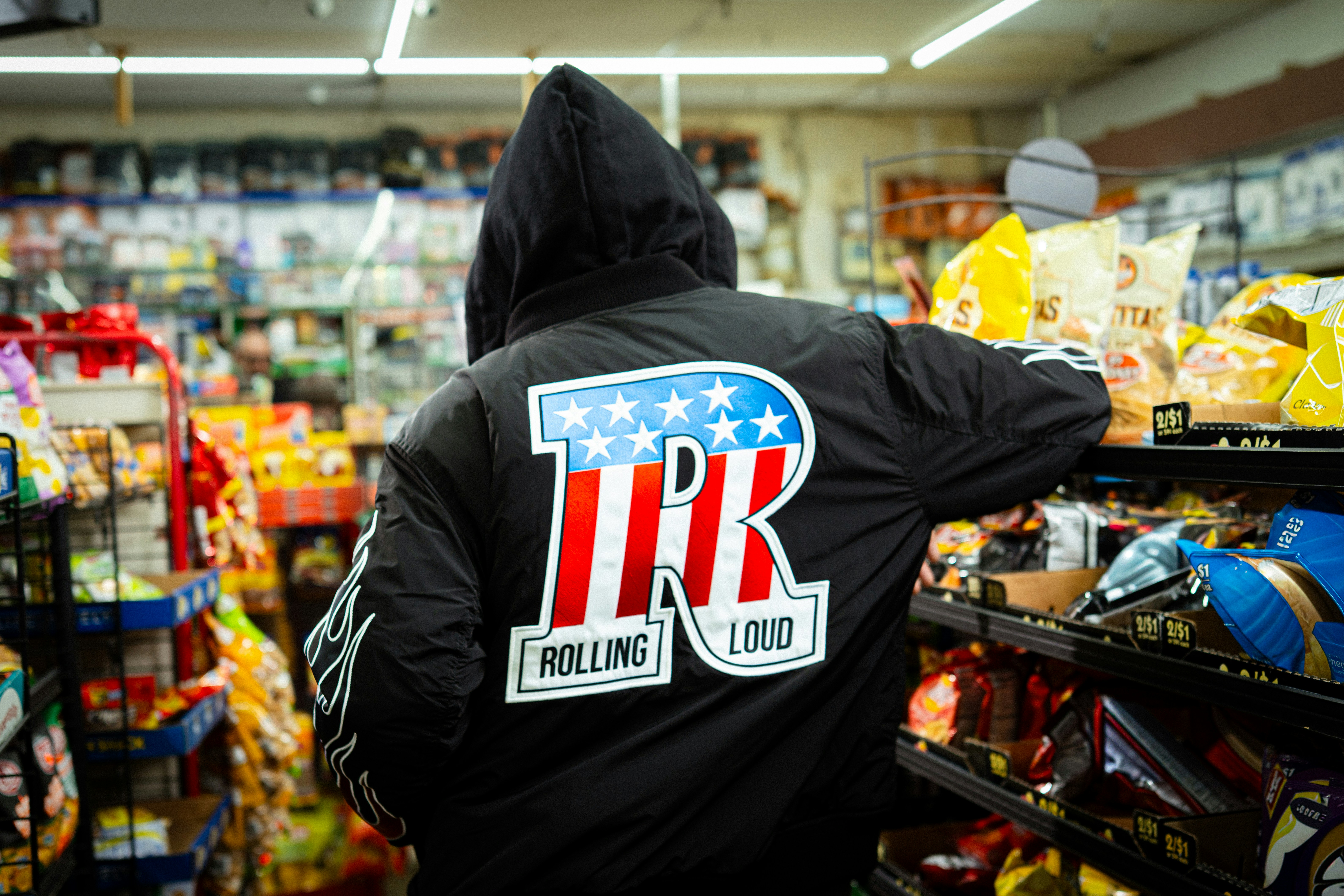Person in black hoodie with "tr" logo in store