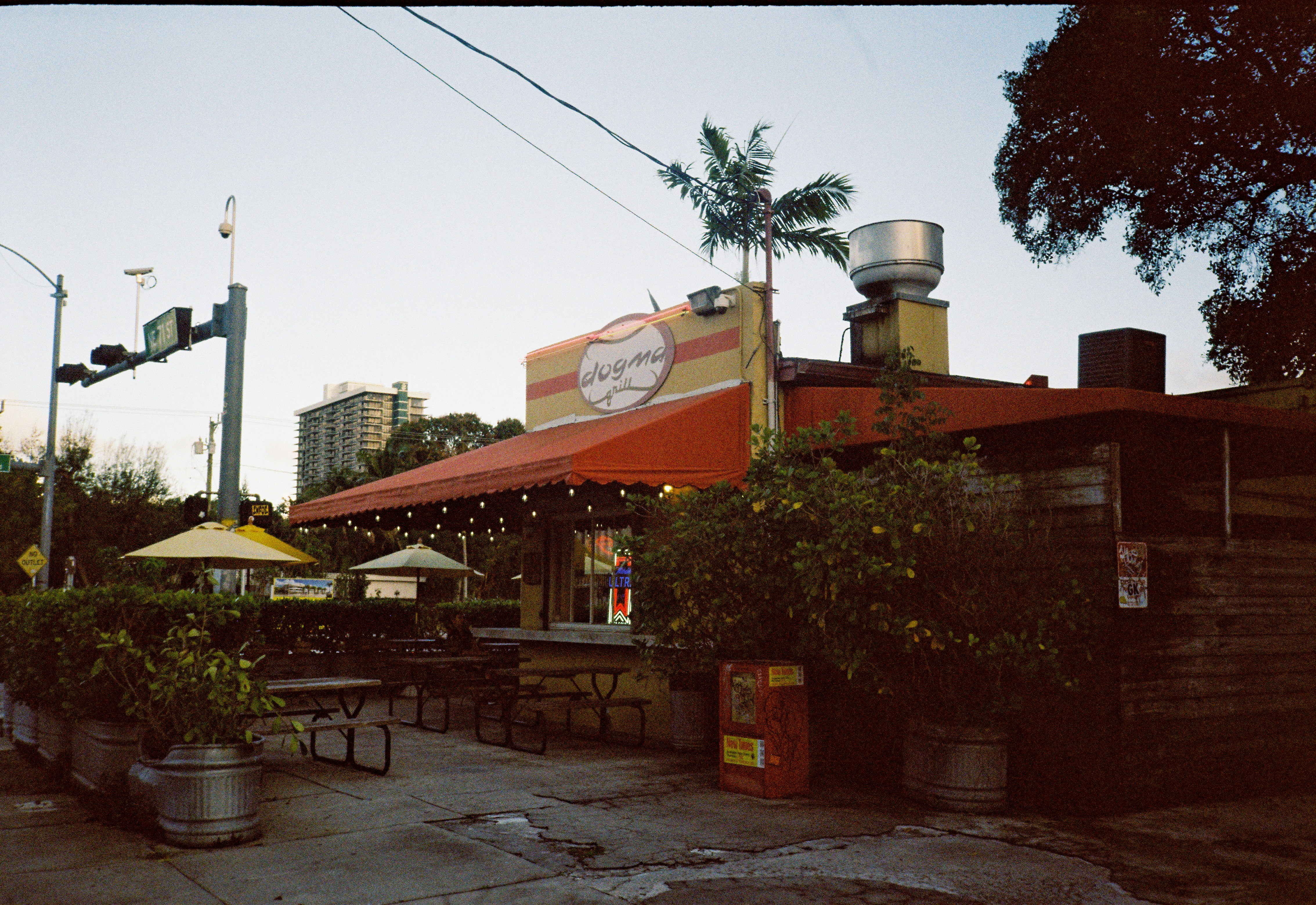 A casual outdoor dining area with a restaurant building.