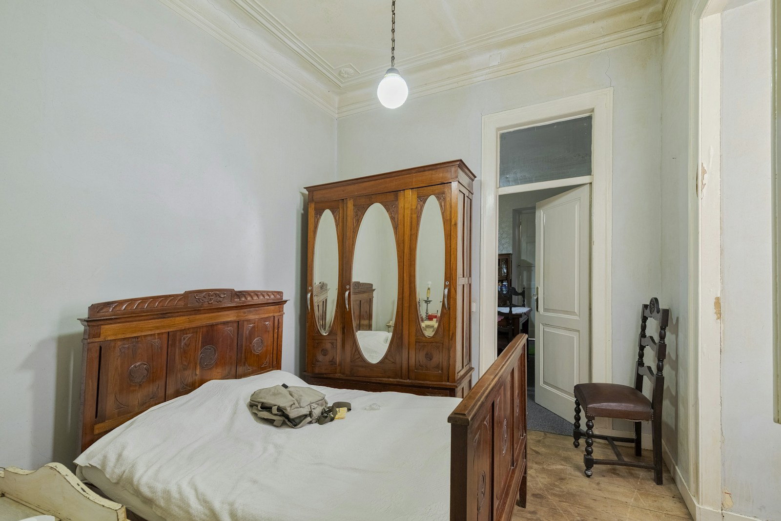 antique armoire wardrobe in pre-war apartment bedroom