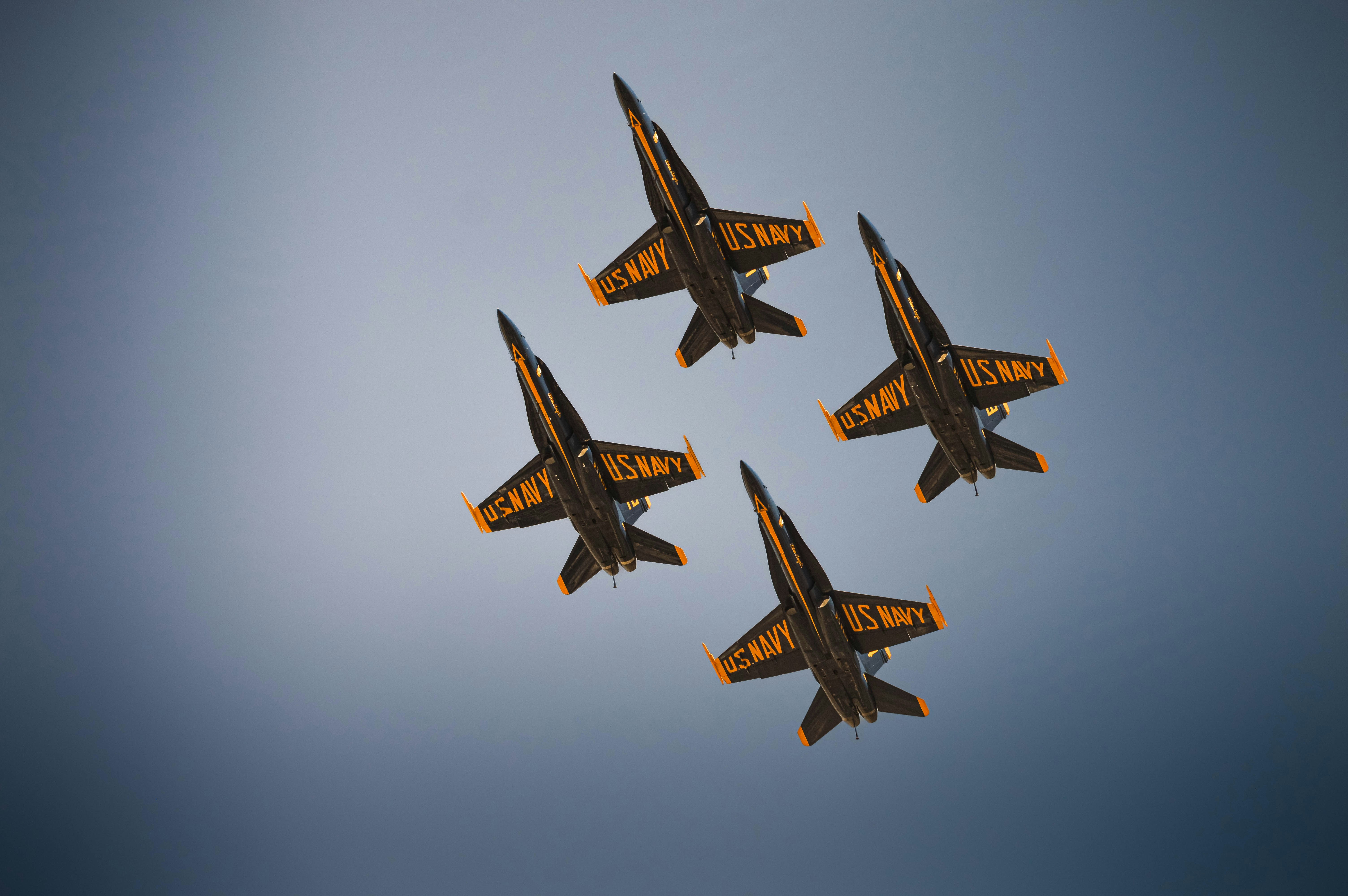 Four fighter jets fly in formation against the sky