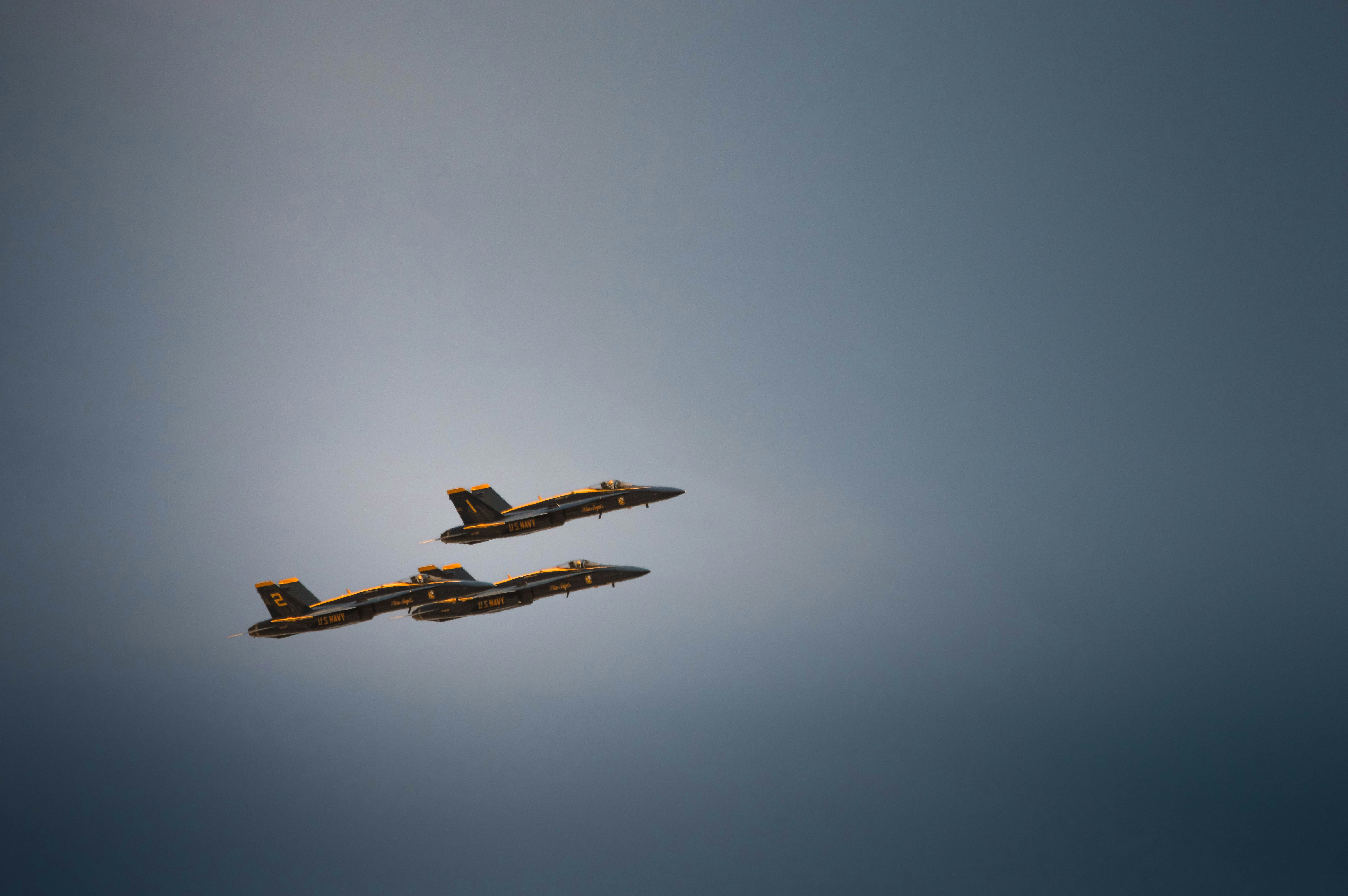 Three fighter jets flying in formation against a blue sky
