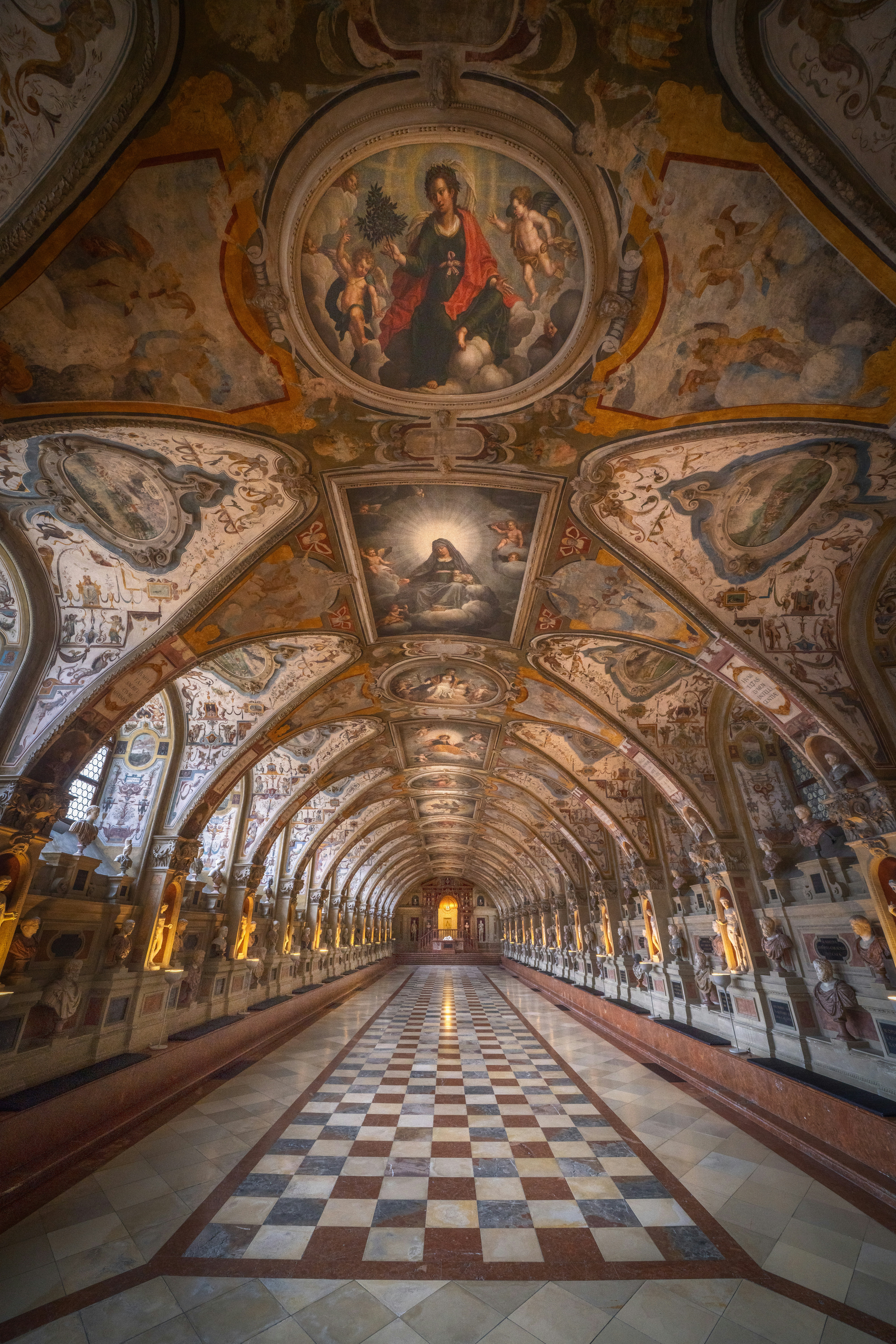 Grand hall with ornate ceiling and checkered floor