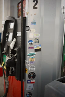 Gas pump covered in various stickers