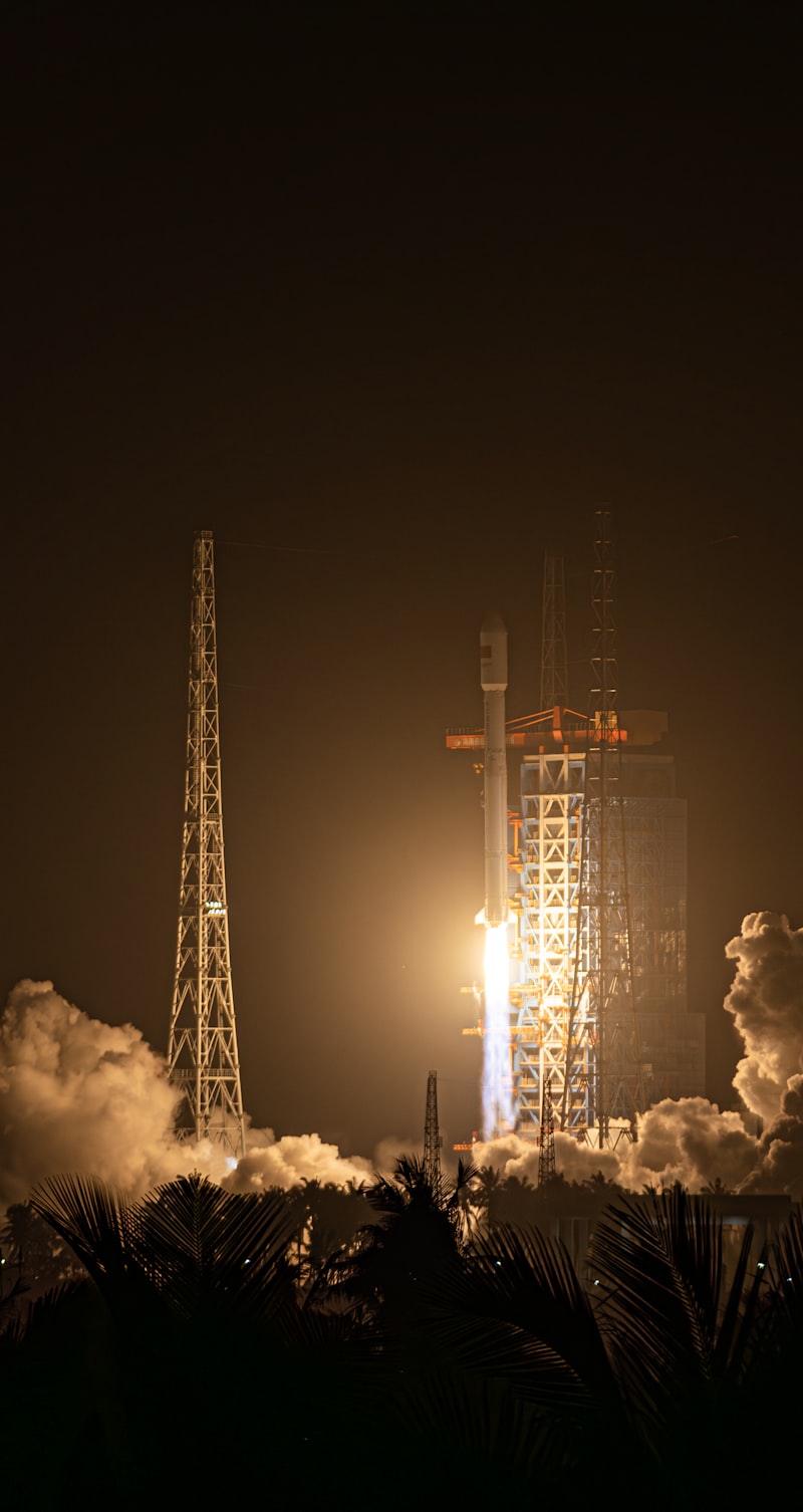 Rocket launch at night with bright flames and smoke