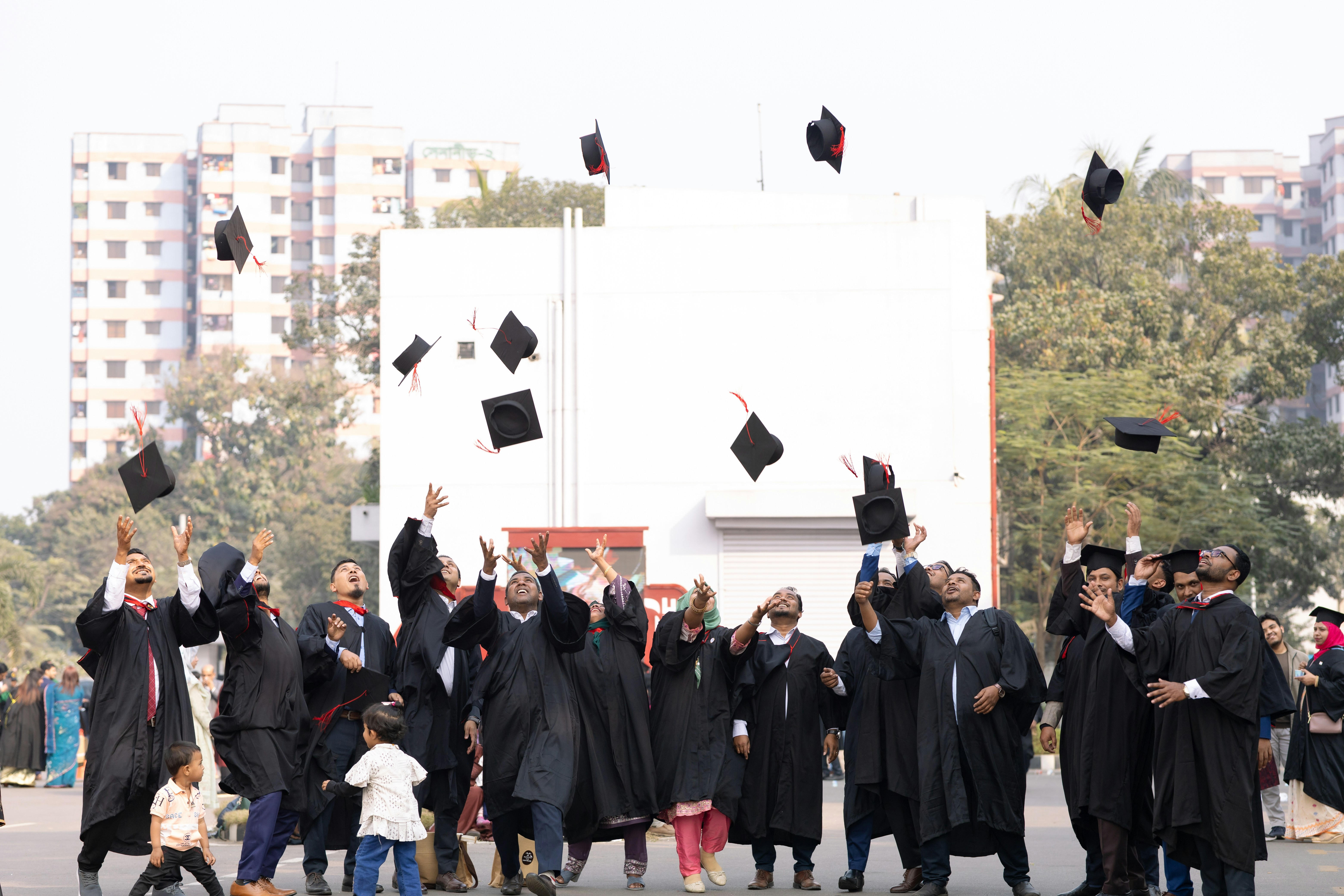 Graduates toss caps in the air celebrating