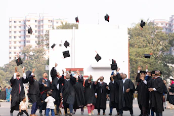 Graduates toss caps in the air celebrating