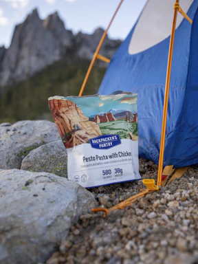 Backpacker's pantry pesto pasta with chicken near tent.