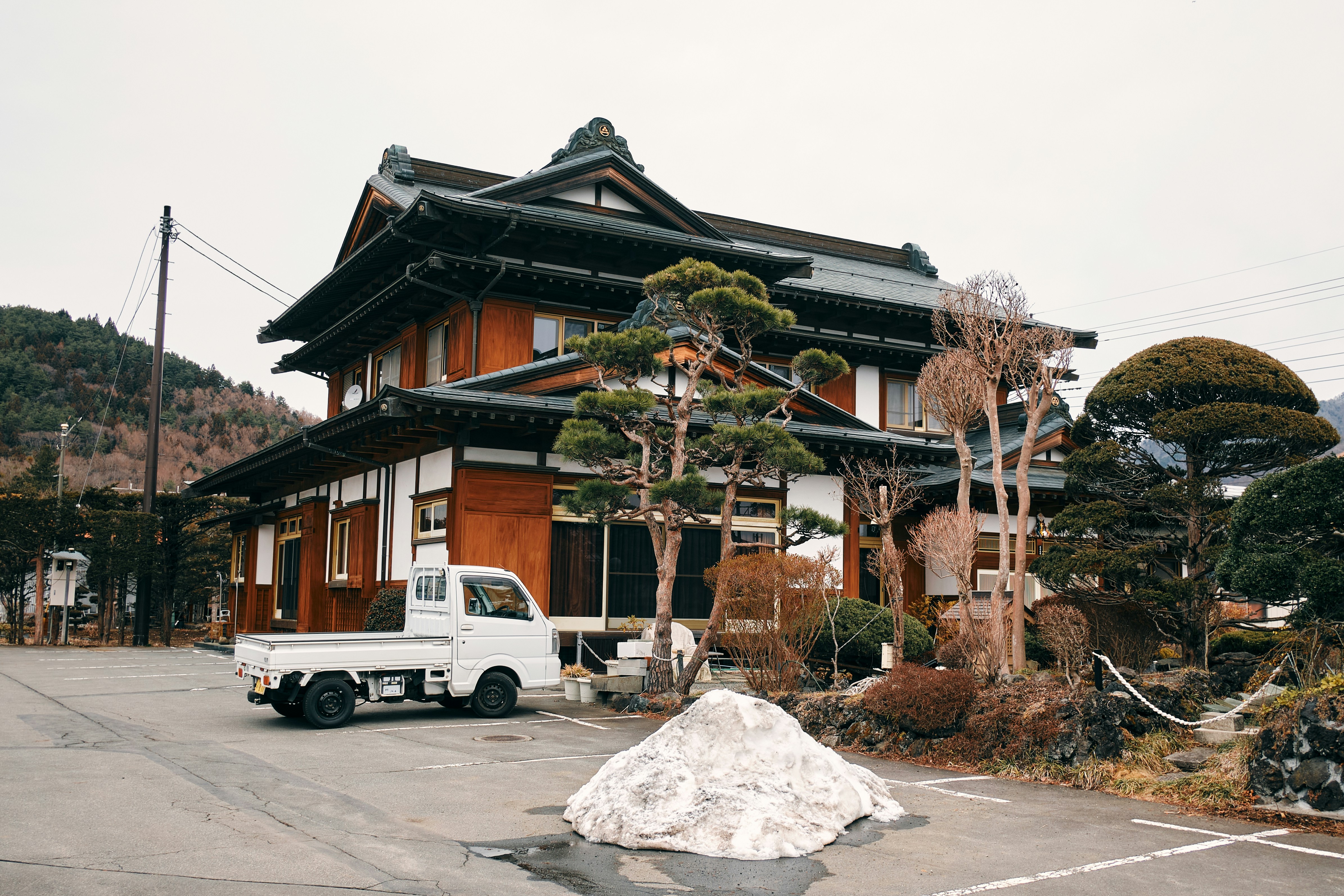 Traditional japanese house with a white truck outside.
