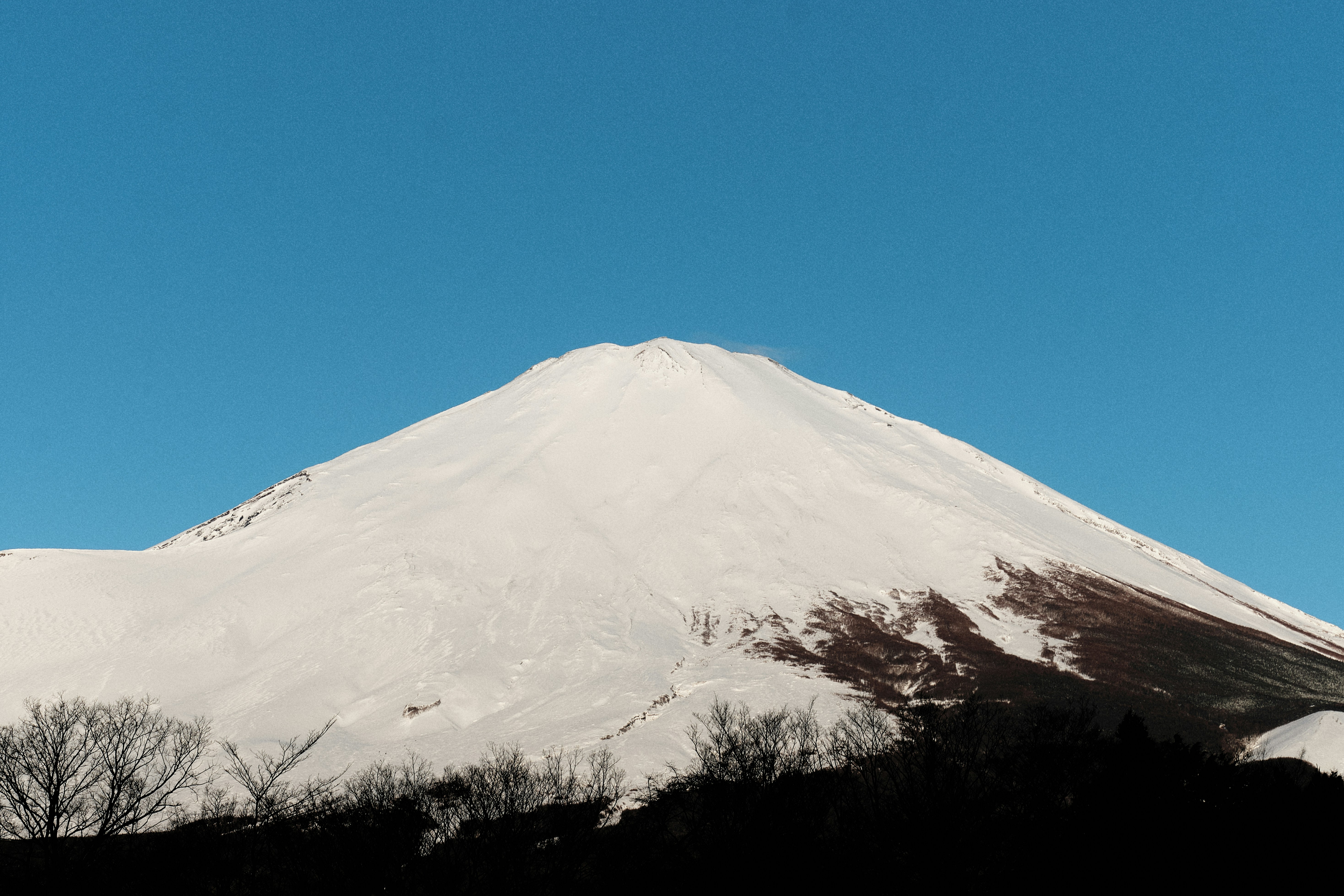 Snow-covered mountain peak under a clear blue sky