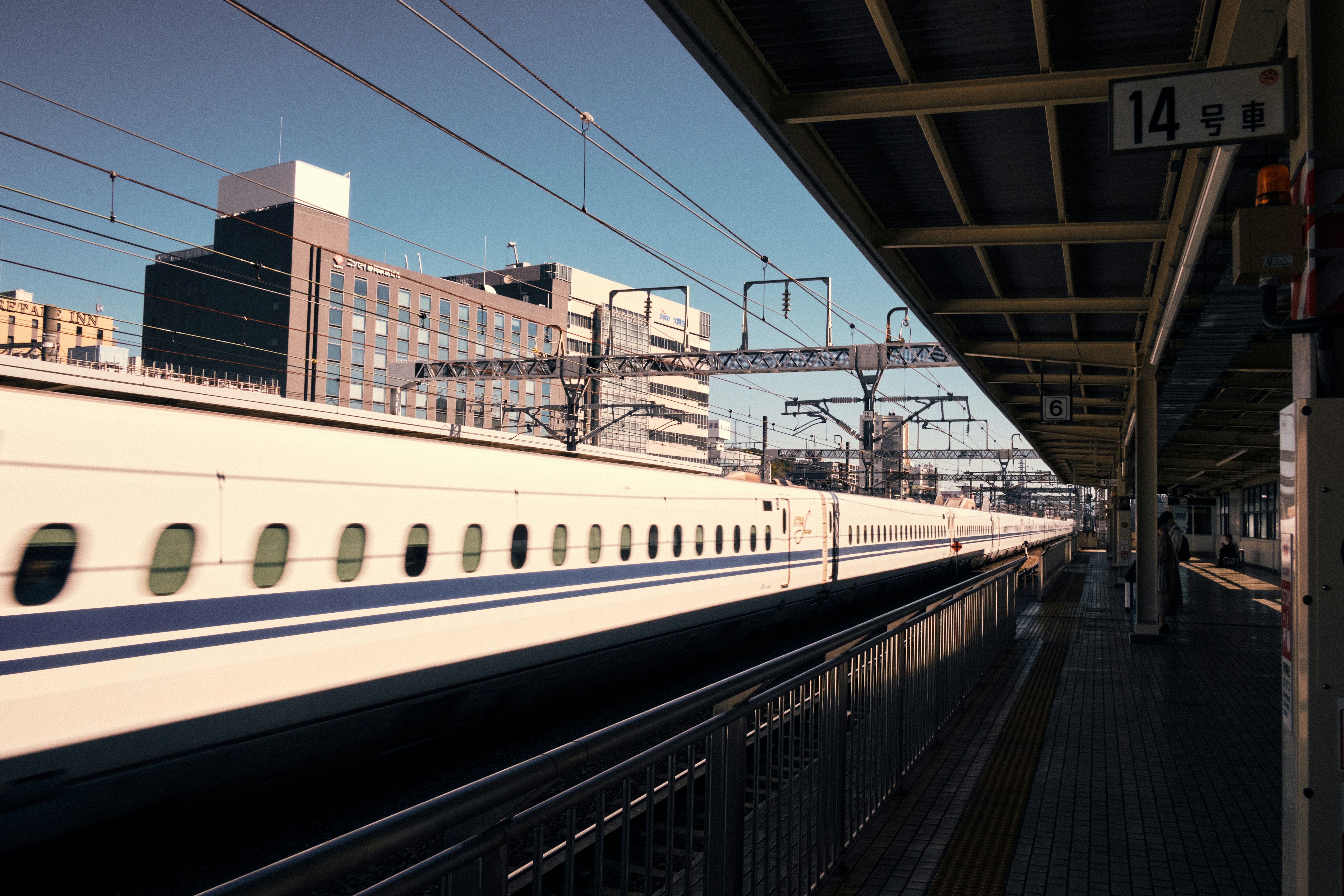Bullet train arriving at a station platform.
