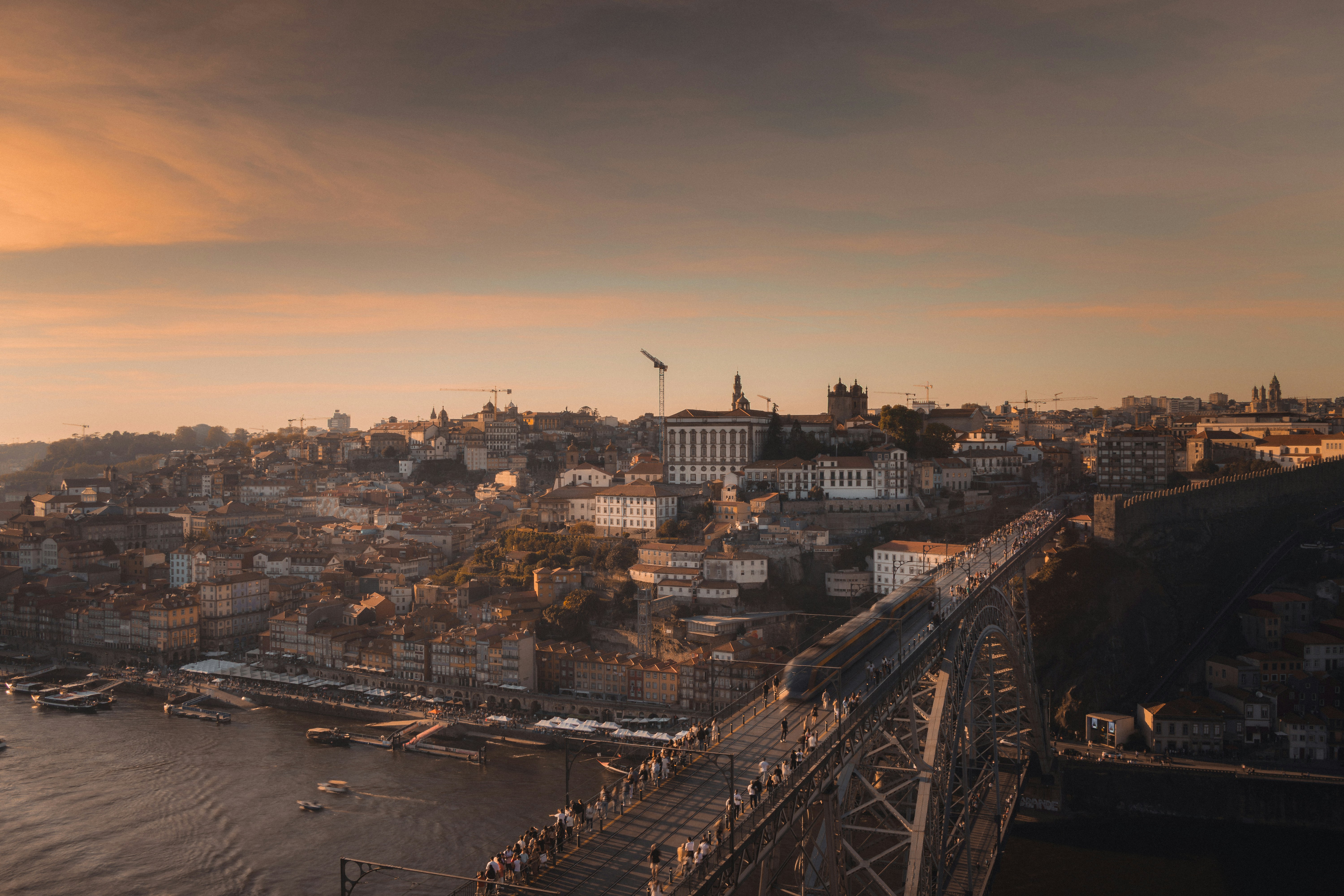 Cityscape with bridge and river at sunset