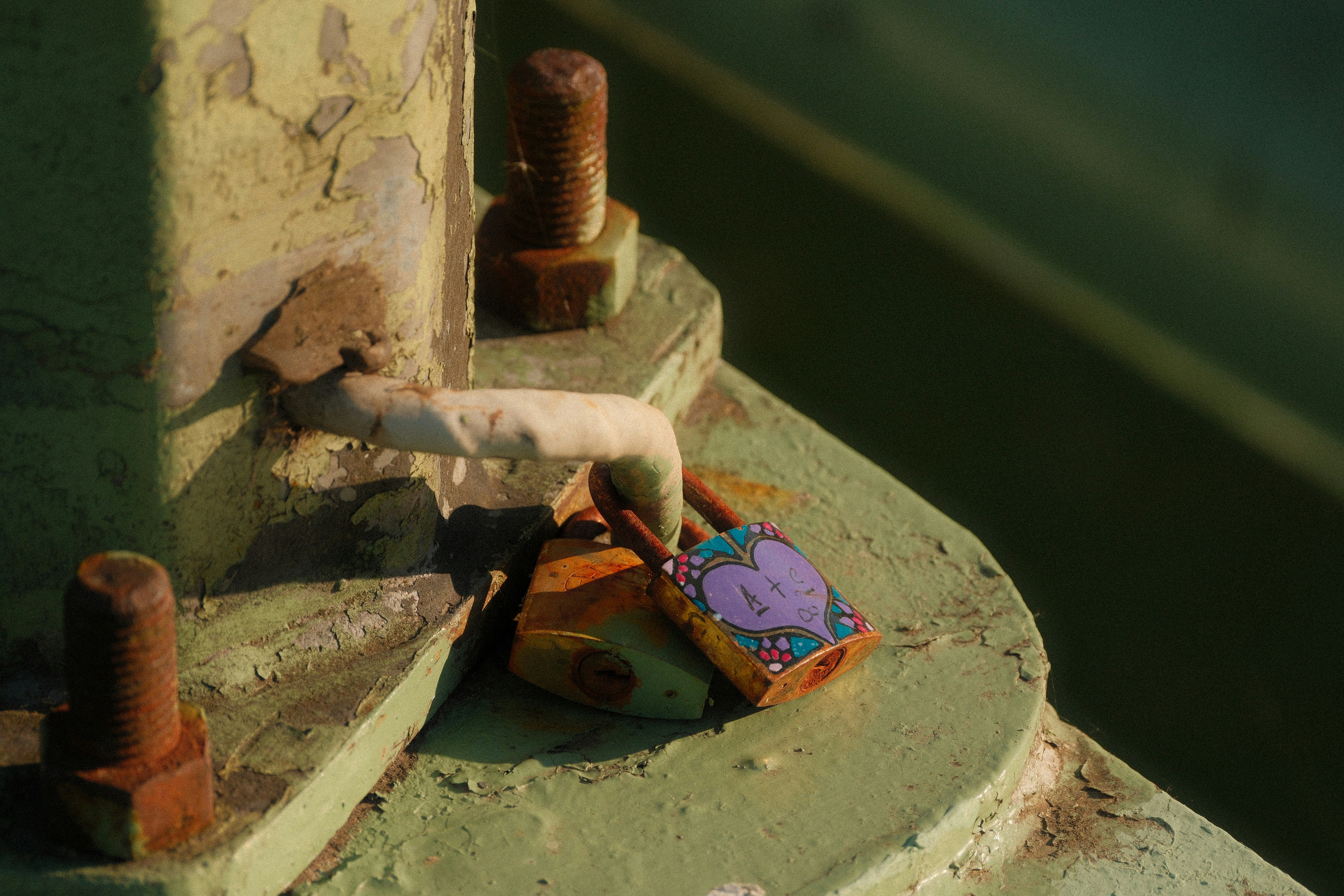 Two padlocks attached to a metal structure