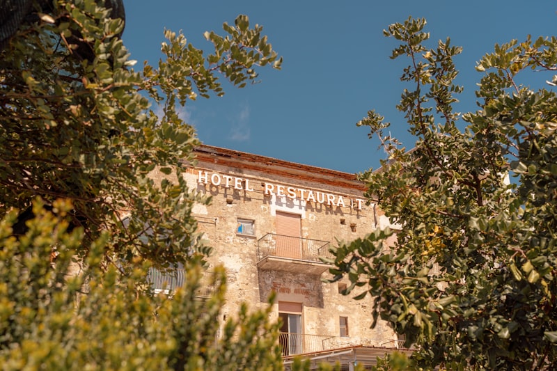 Old hotel building with trees in foreground