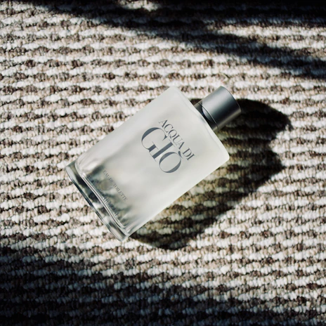 Acqua di gio perfume bottle on textured surface