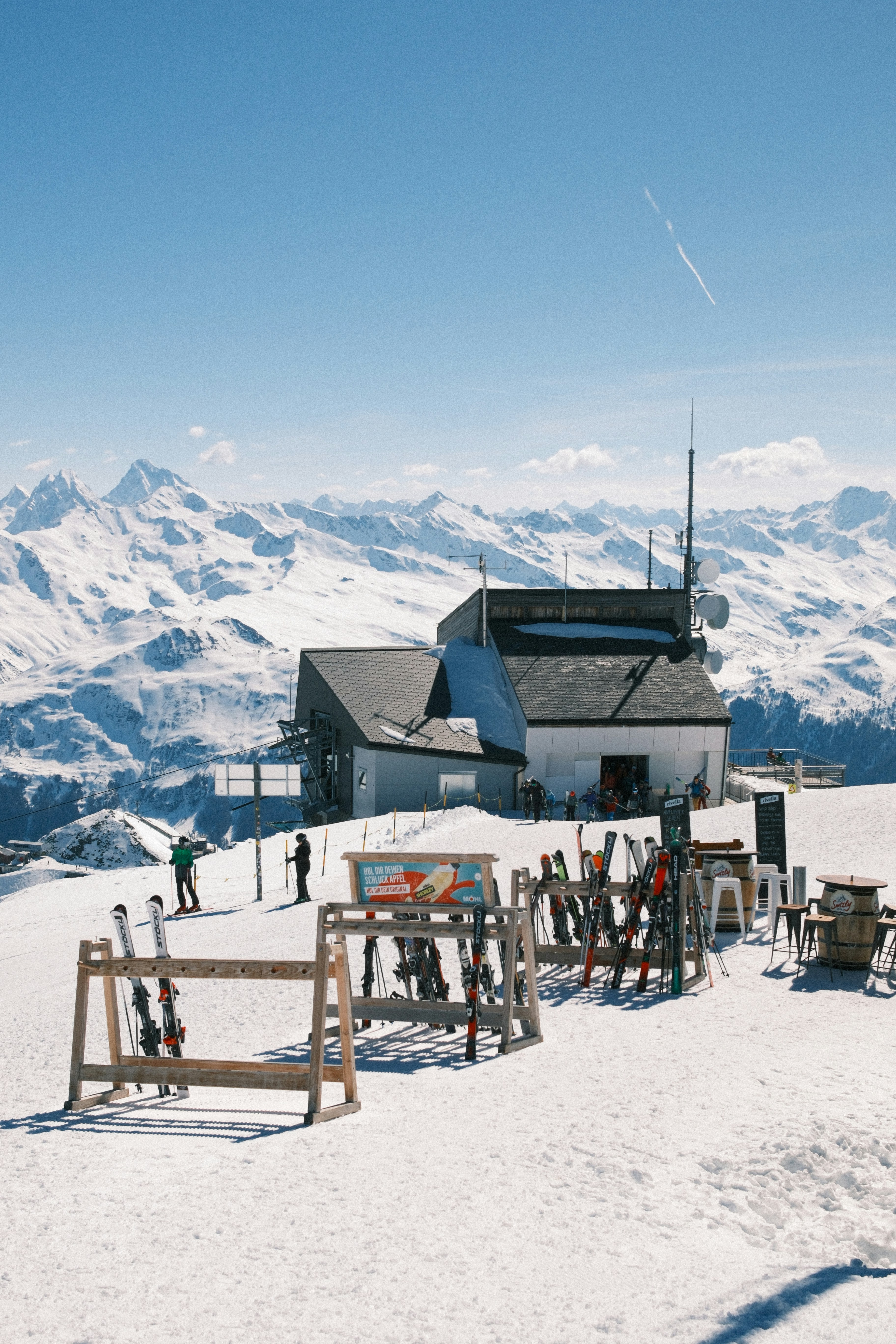Ski resort with snow-covered mountains and clear blue sky