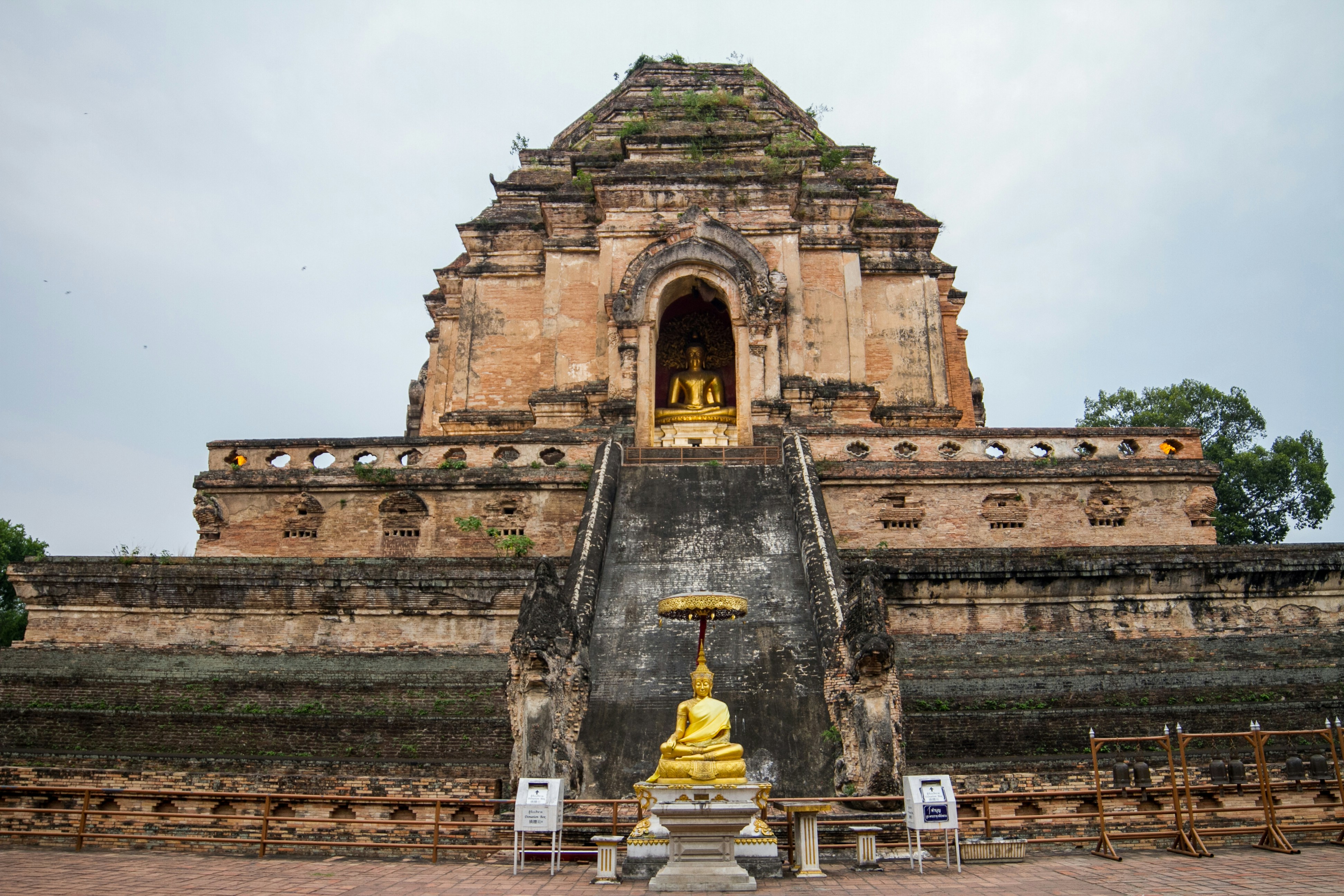 Ancient buddhist temple with golden buddha statues