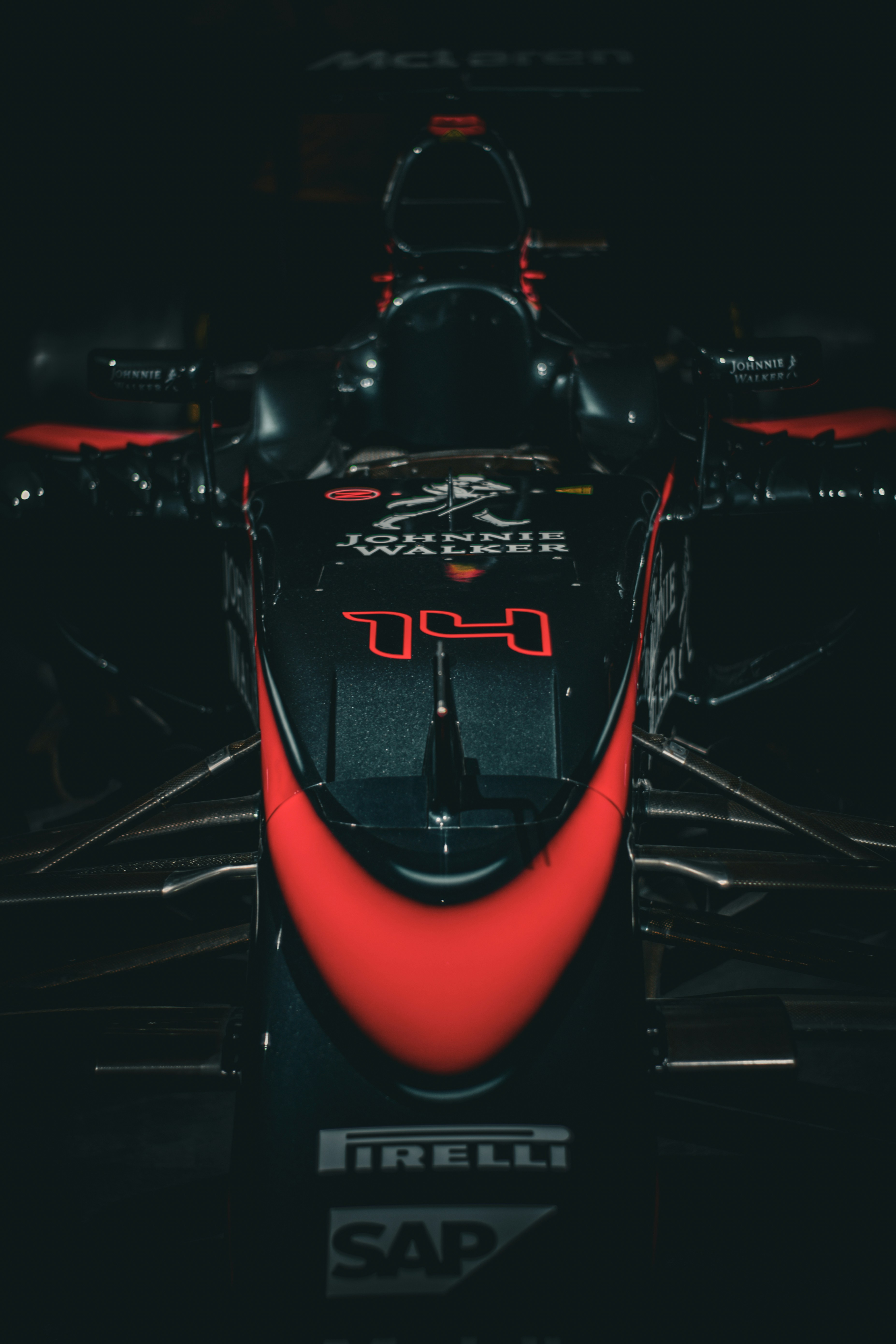 A dark, front view of a race car.