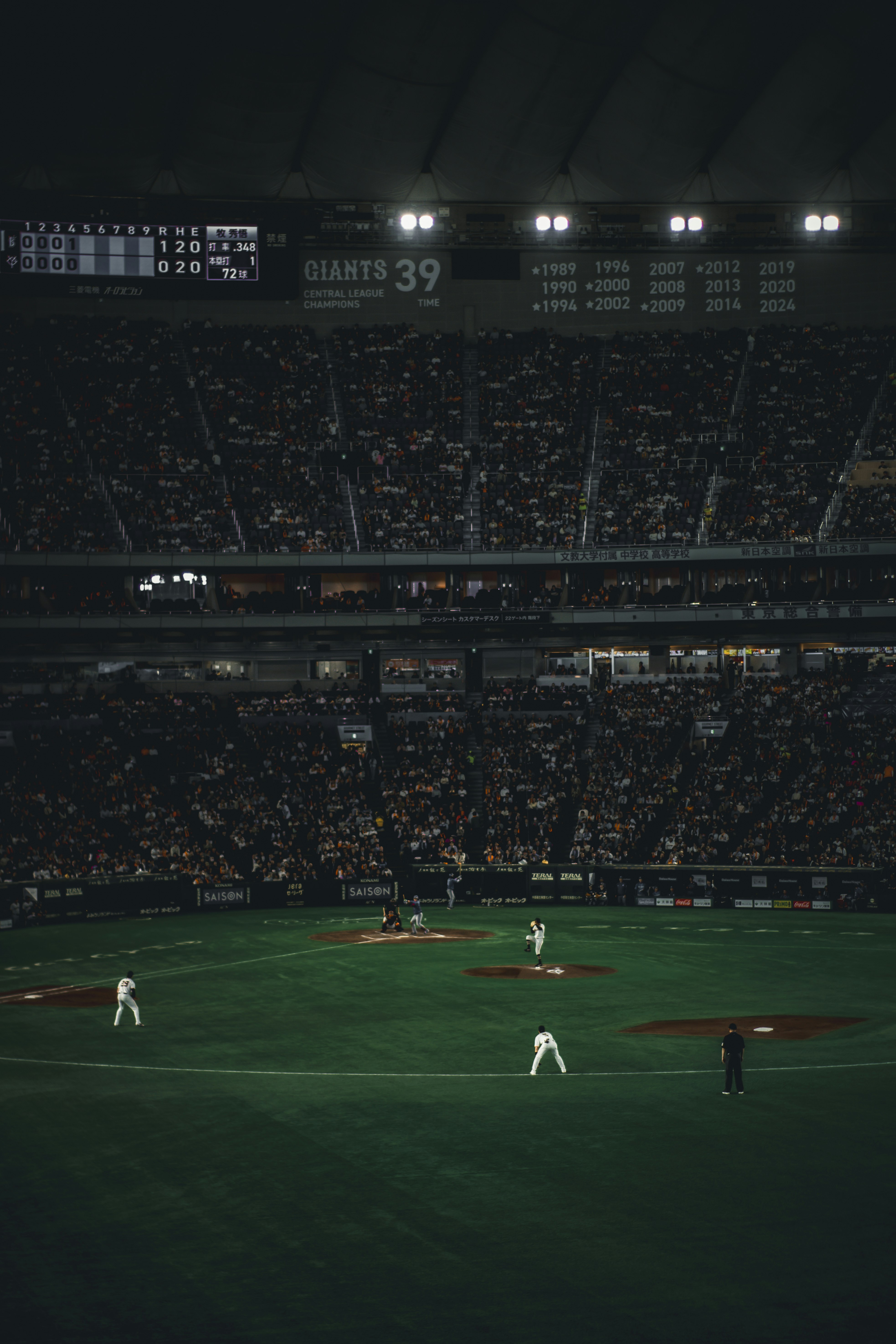 Baseball players on the field during a night game