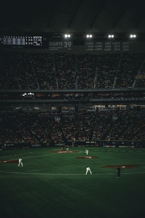 Baseball players on the field during a night game, the kind of setting the Cosmic Takeover Tour turns into a black light show