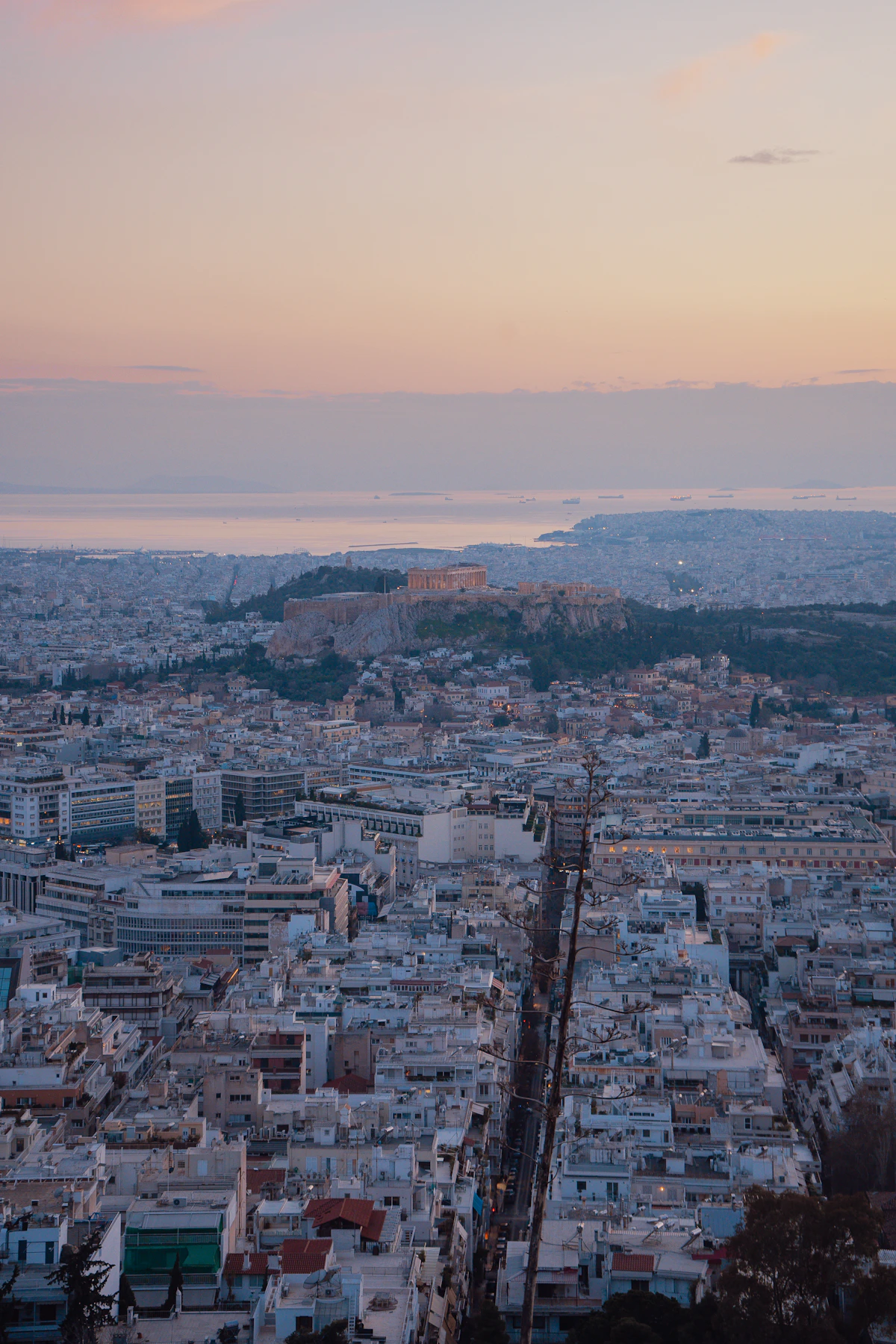 Athens spreading around the illuminated Acropolis in the warm light of sunset
